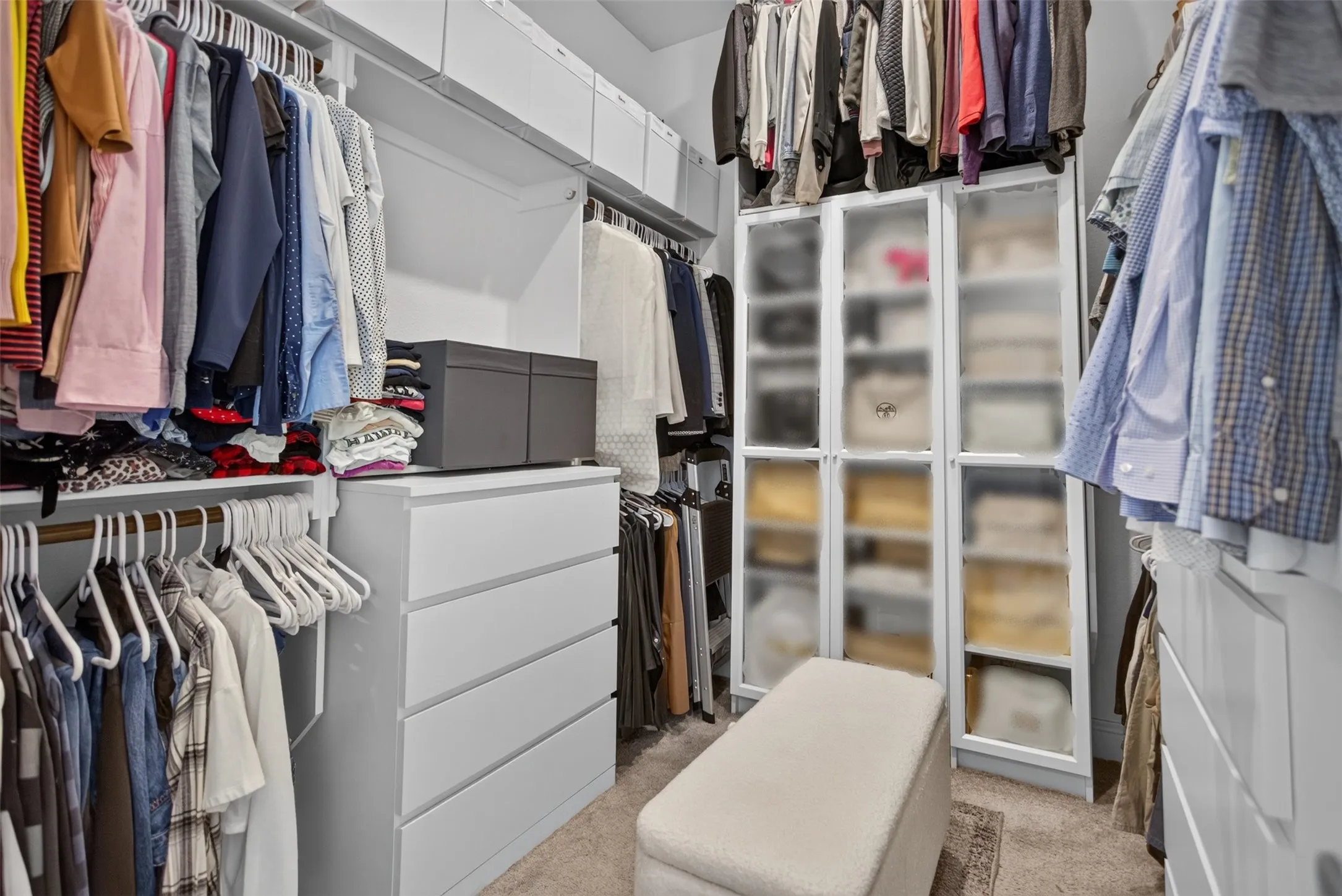 Custom closet system featuring built-in shelving, hanging rods, and integrated drawer storage