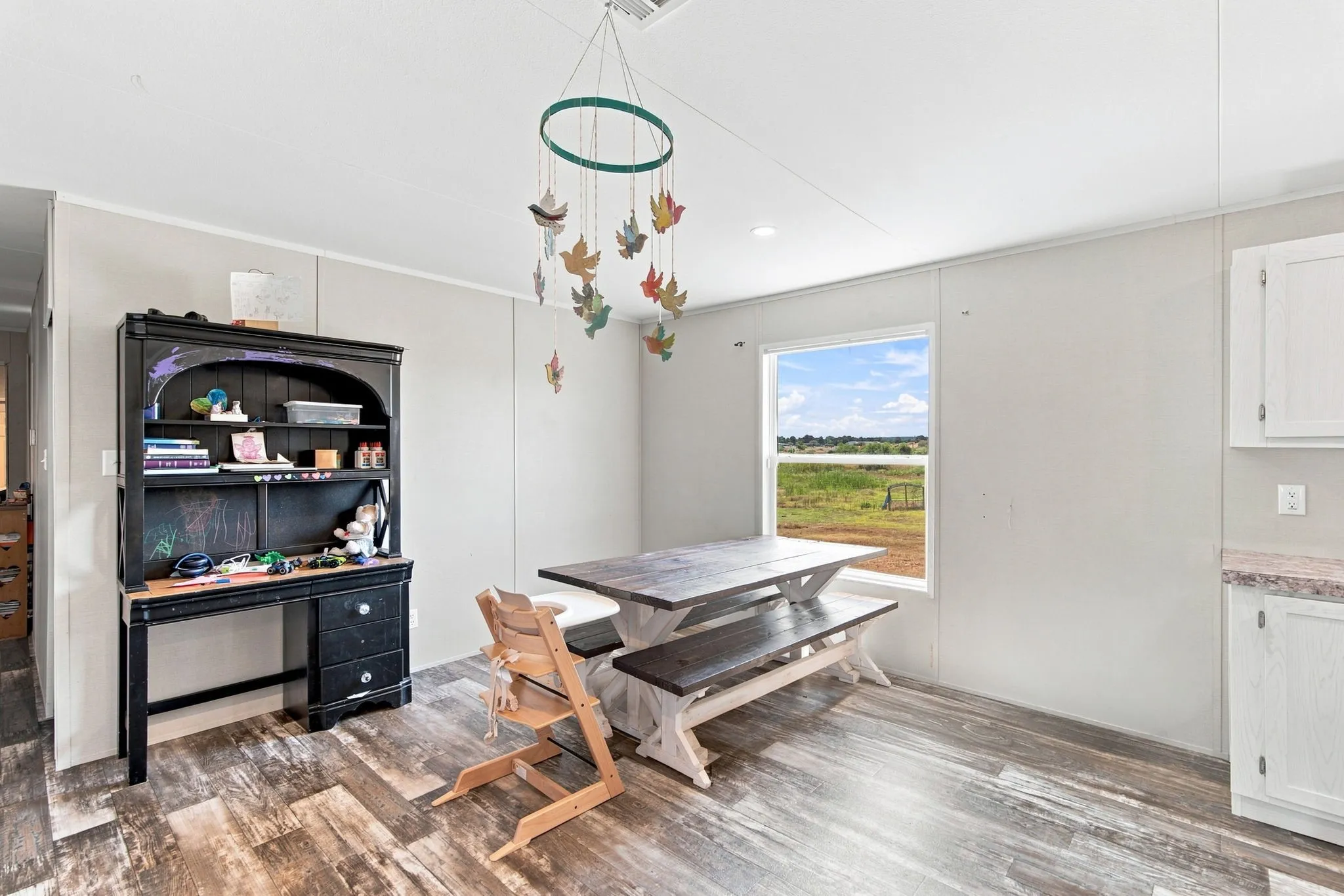 Wood-finish flooring, white walls, and a recessed ceiling light