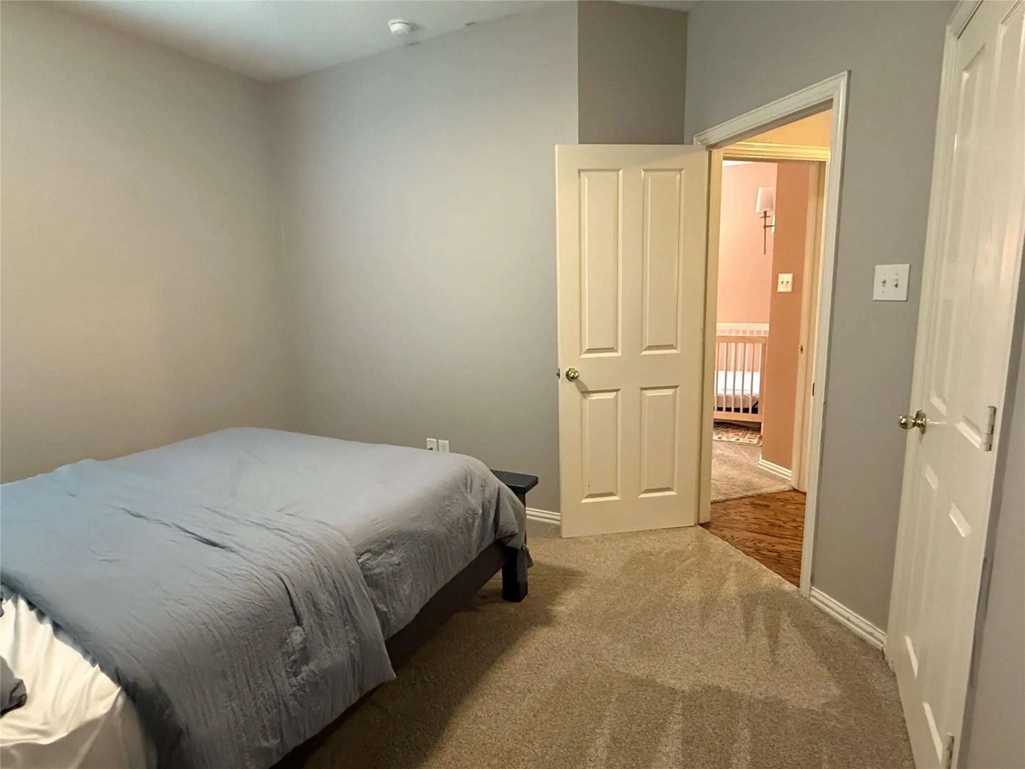 Carpeted flooring, neutral wall paint, and white trim throughout