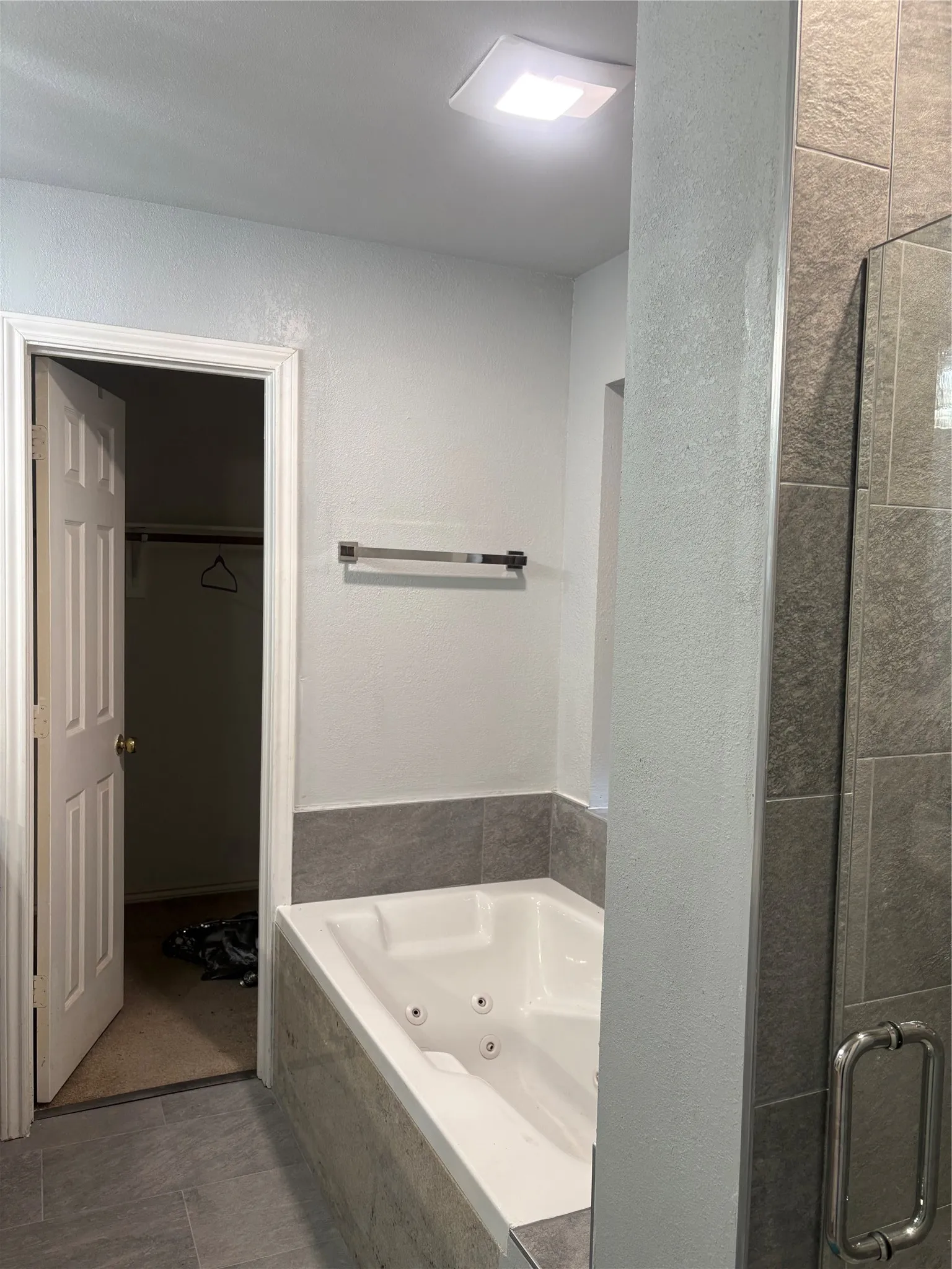 Bathroom features jetted tub and separate shower