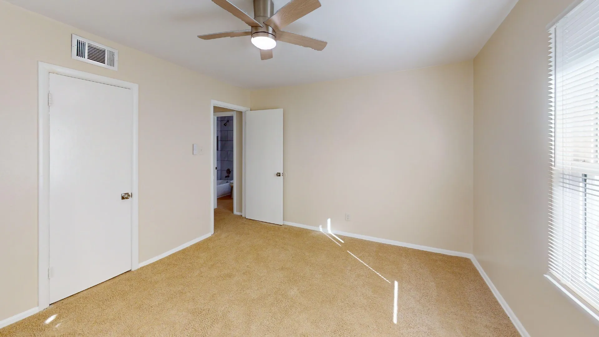 Carpeted flooring, ceiling fan with integrated lighting, white interior doors, and window with blinds