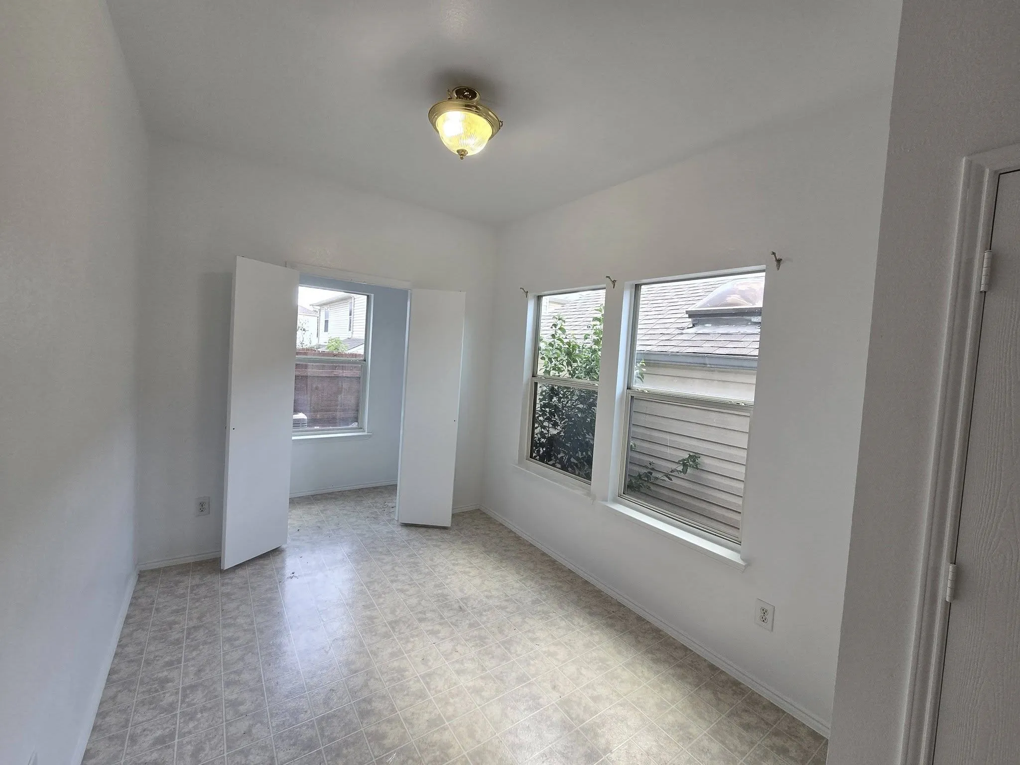 Room featuring neutral wall finishes and patterned flooring
