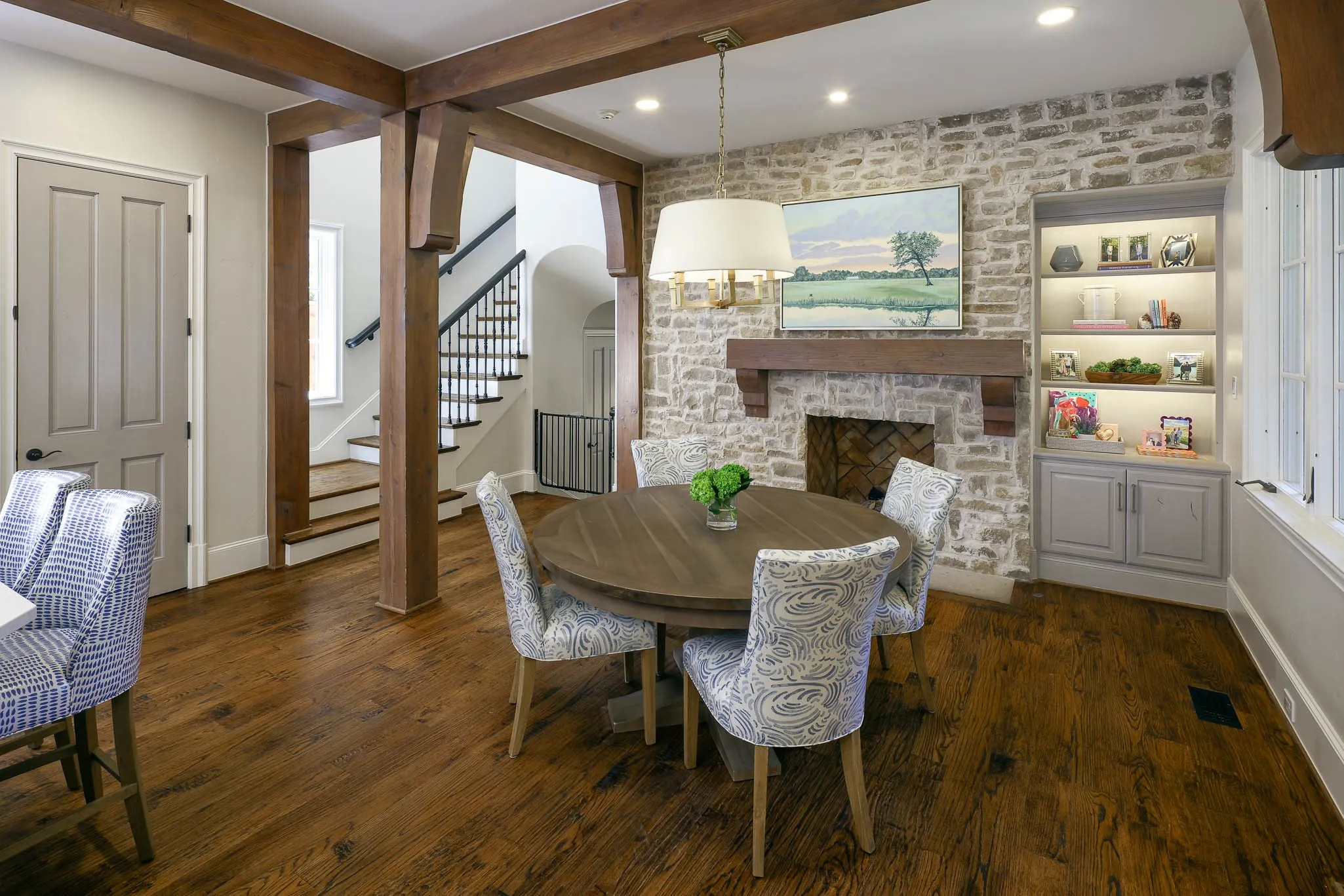 Breakfast room with gas fireplace, stone wall, and built-in shelving