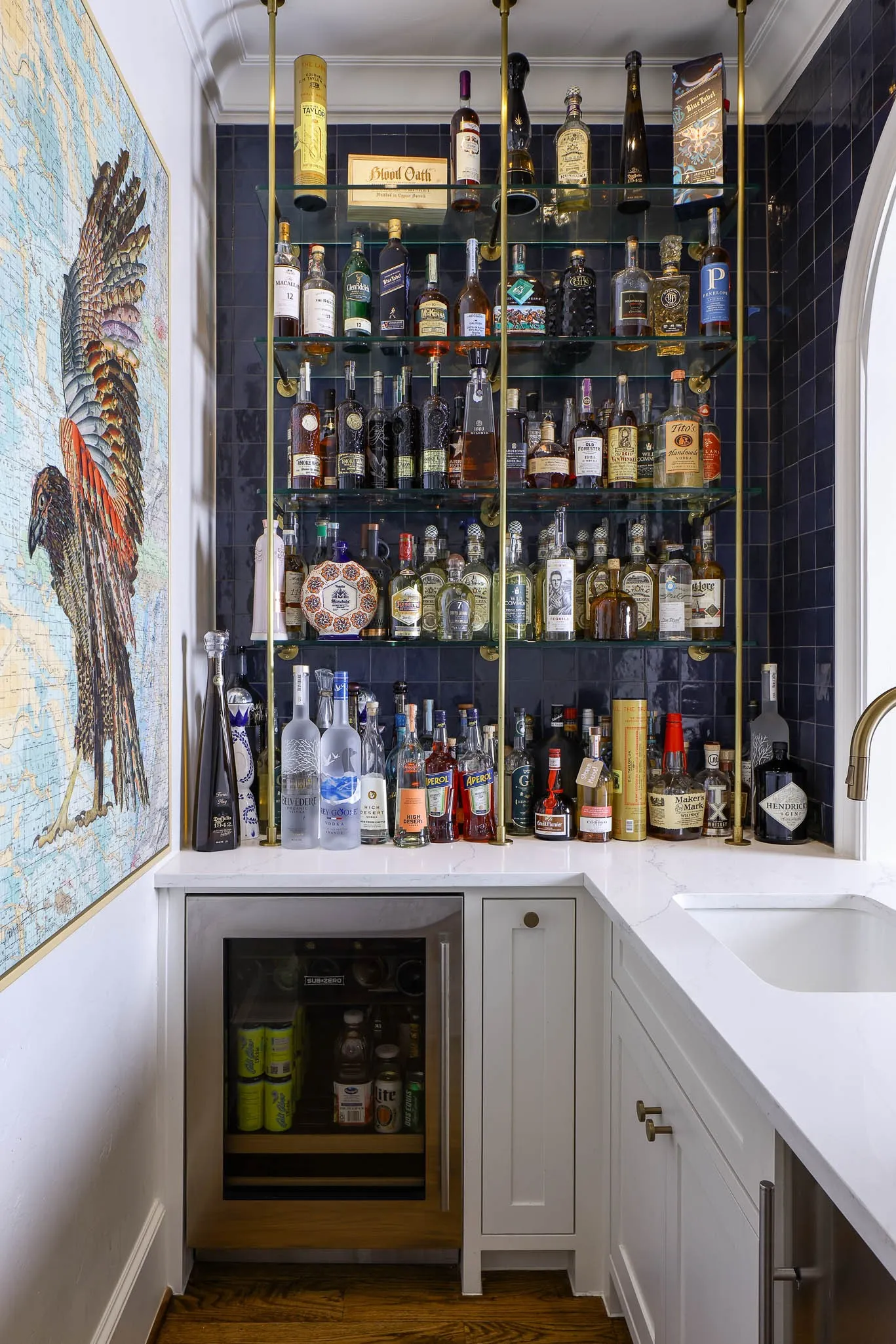 Wet bar with Sub-Zero beverage refrigerator, Scotsman ice maker, and built-in glass shelving