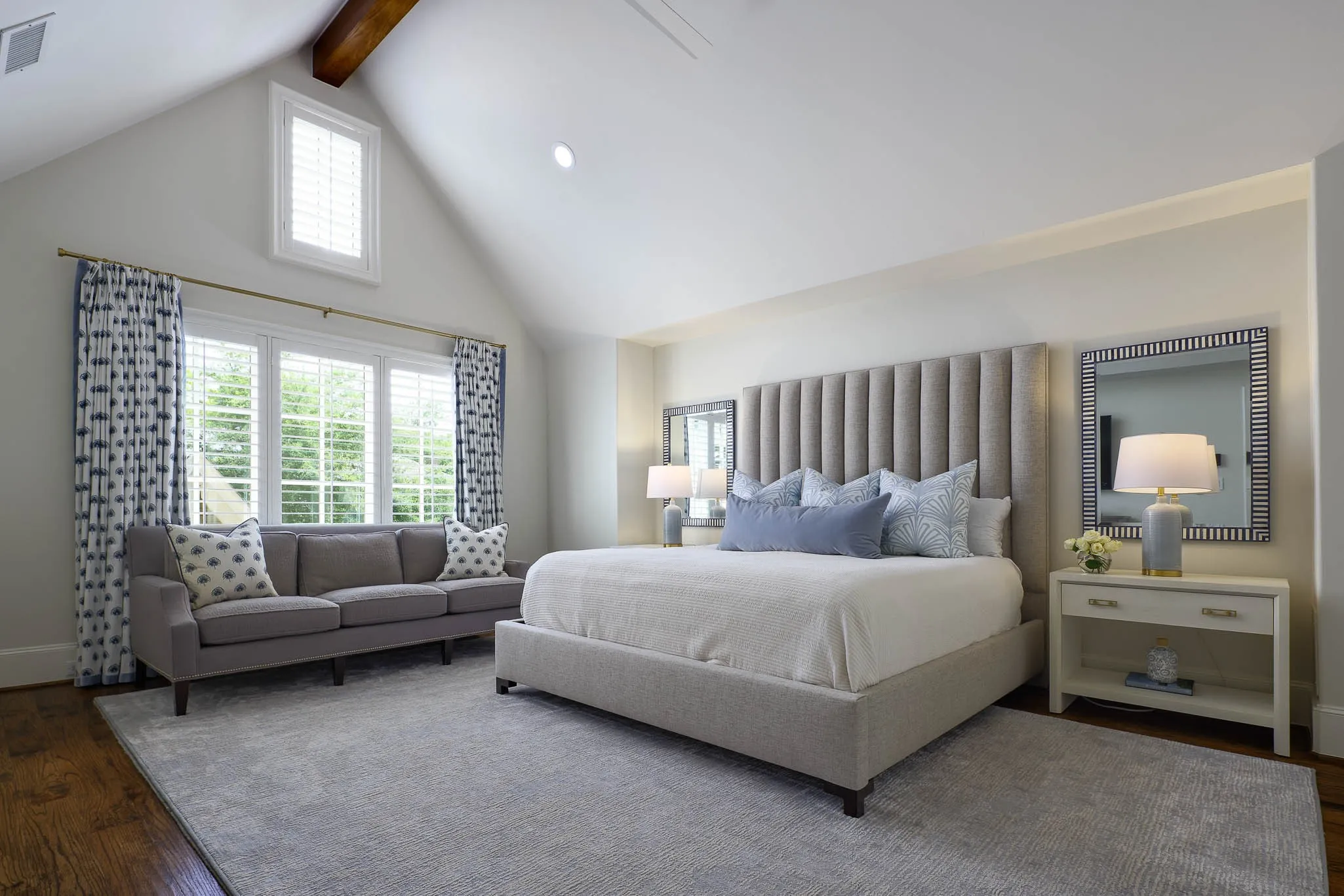 Primary suite with vaulted wood beamed ceiling and sitting area