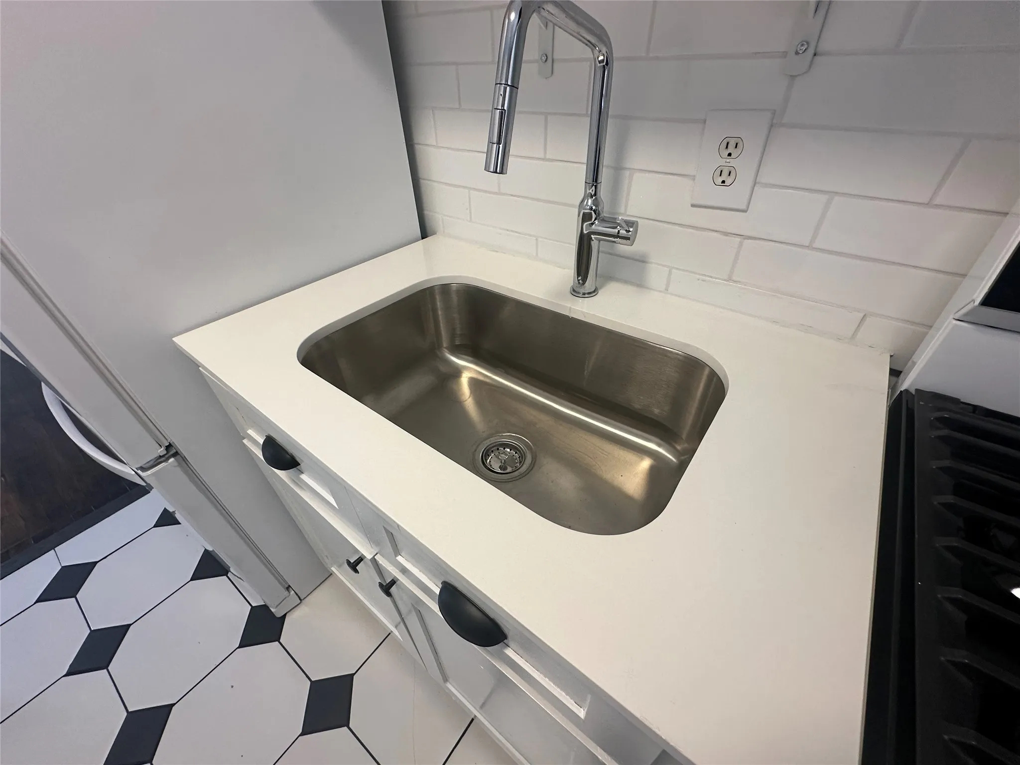 Stainless steel sink with a chrome gooseneck faucet