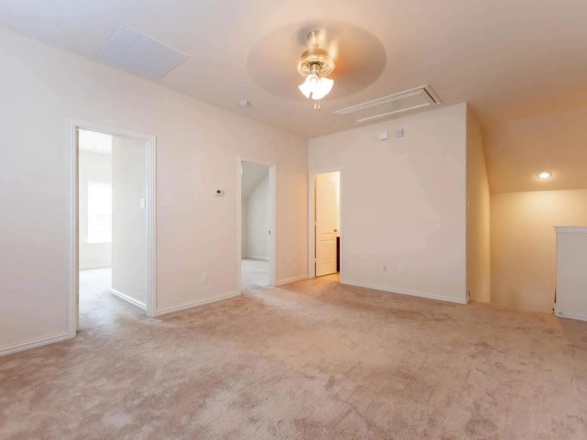 Carpeted landing with a ceiling fan, recessed lighting, and multiple entryways