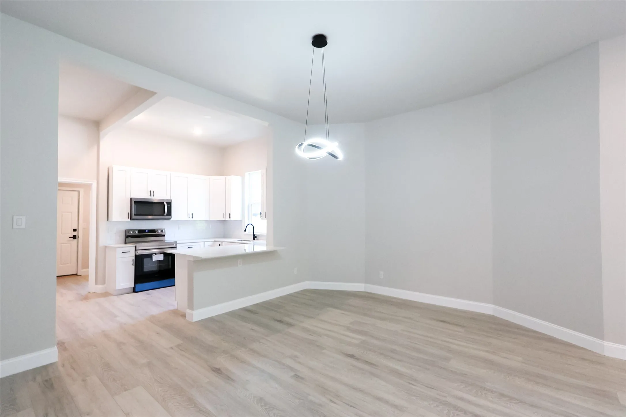 Open-concept living area with wood-finish flooring