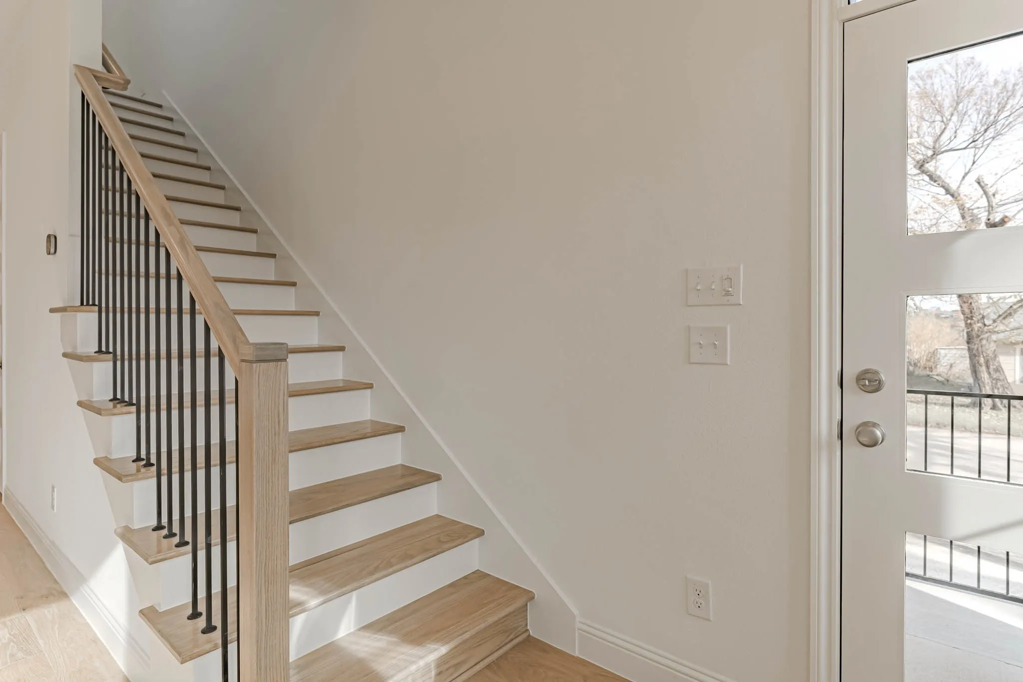 Wood stairs to second level with open railing