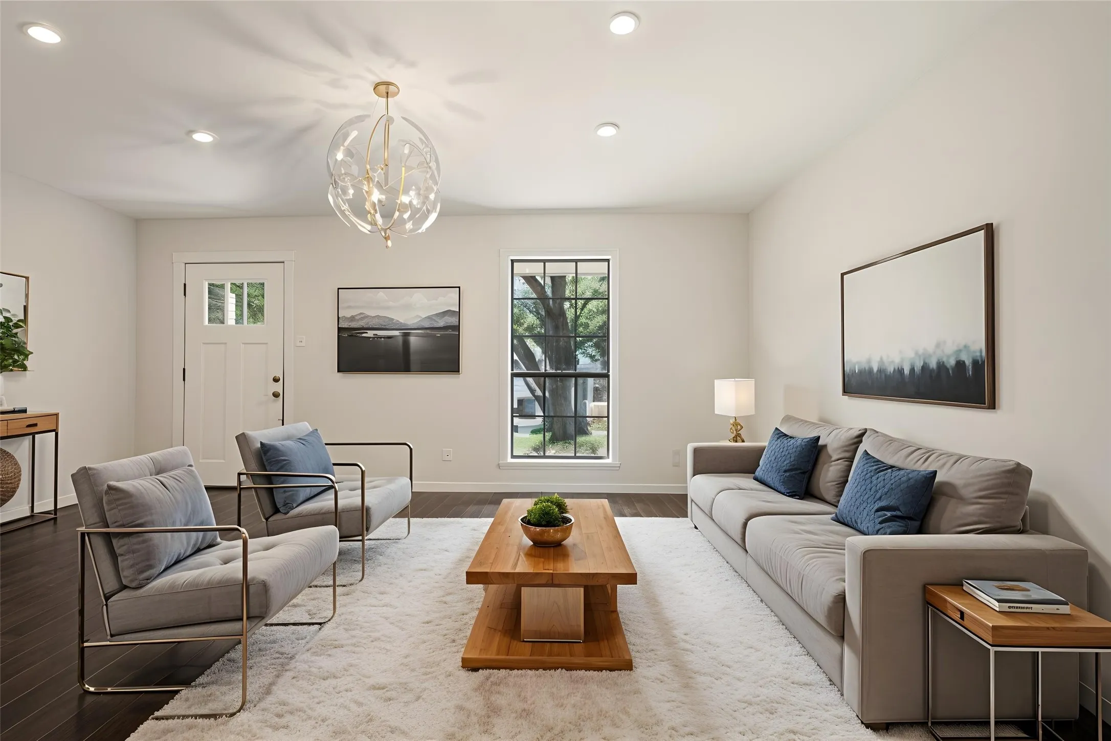 Recessed lighting, wood-finish flooring, and a decorative chandelier