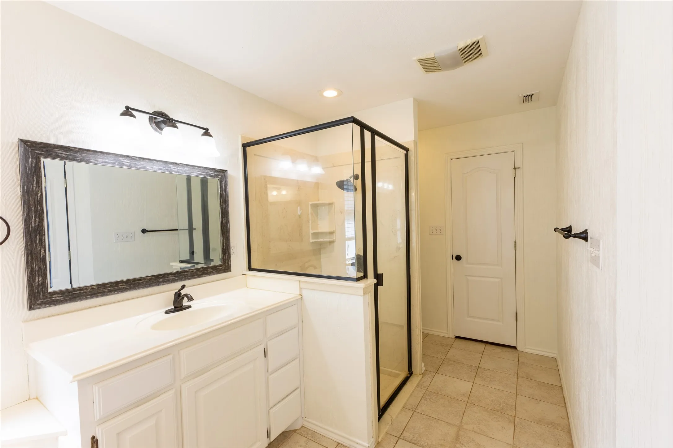 Primary bathroom has separate shower and vanities.