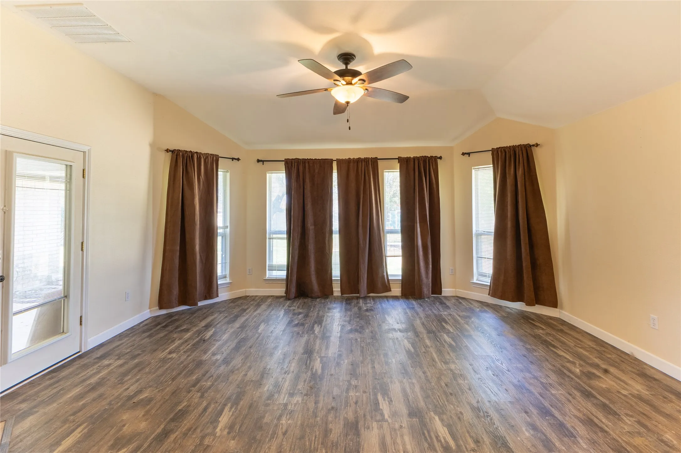Spacious Den leads to patio.