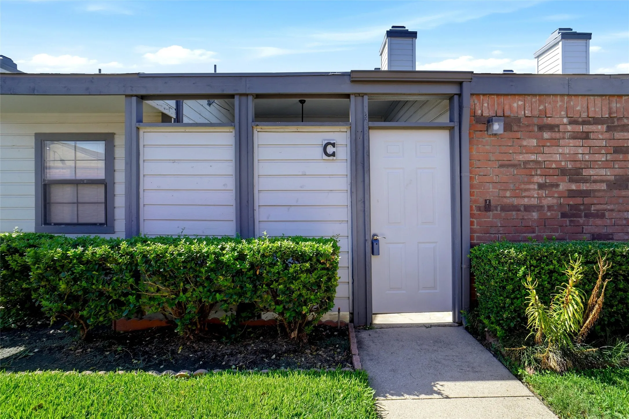 Brick exterior*Light gray siding with Dark accents* Well landscaped lawns