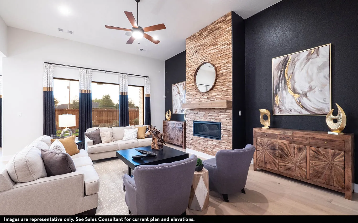Spacious living area featuring high ceilings, wood-finish flooring, an integrated fireplace with a stone surround, and large windows