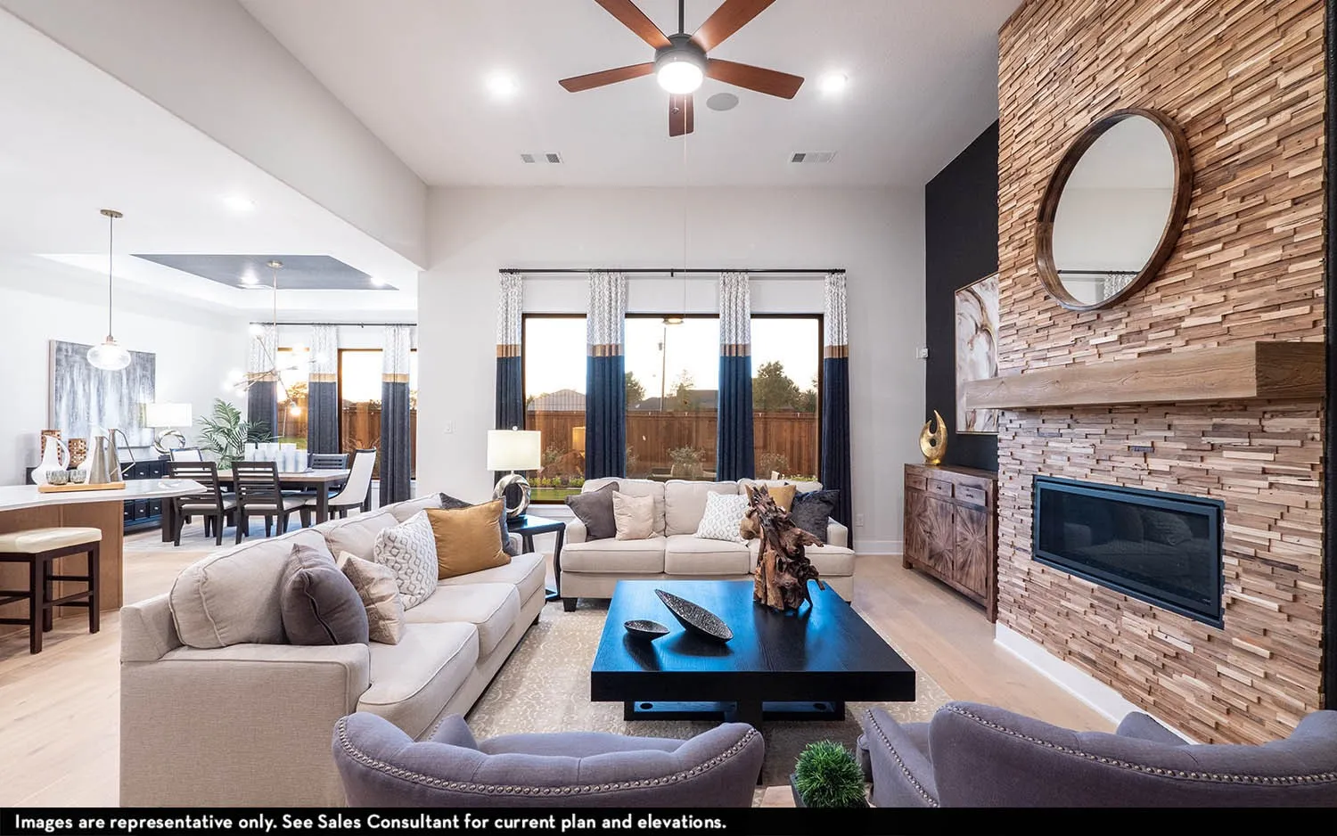 Spacious living area featuring high ceilings, wood-finish flooring, and large windows