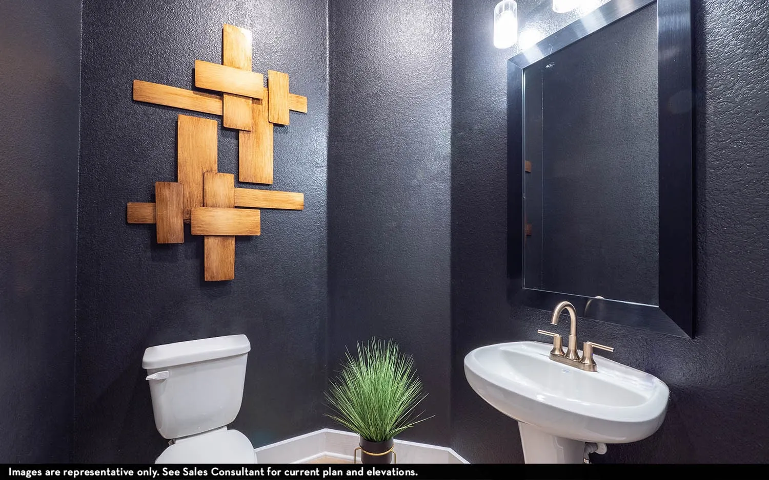 Pedestal sink with a brushed nickel faucet, large rectangular mirror, and an overhead vanity light fixture