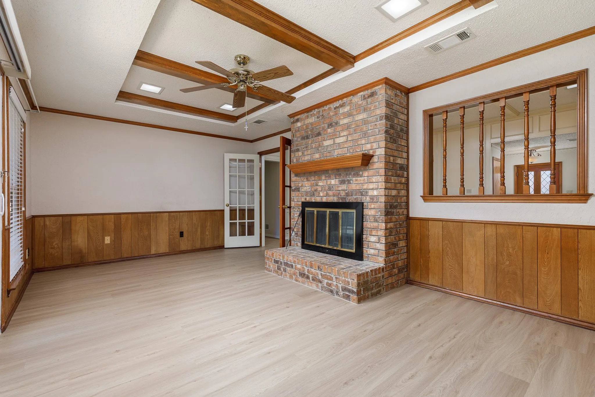 Brick-faced fireplace with a wood mantel