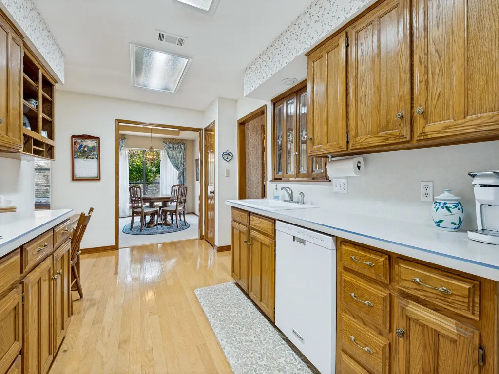 Light and bright kitchen with lots of counter space and storage cabinets, including pot drawers under the cooktop.
