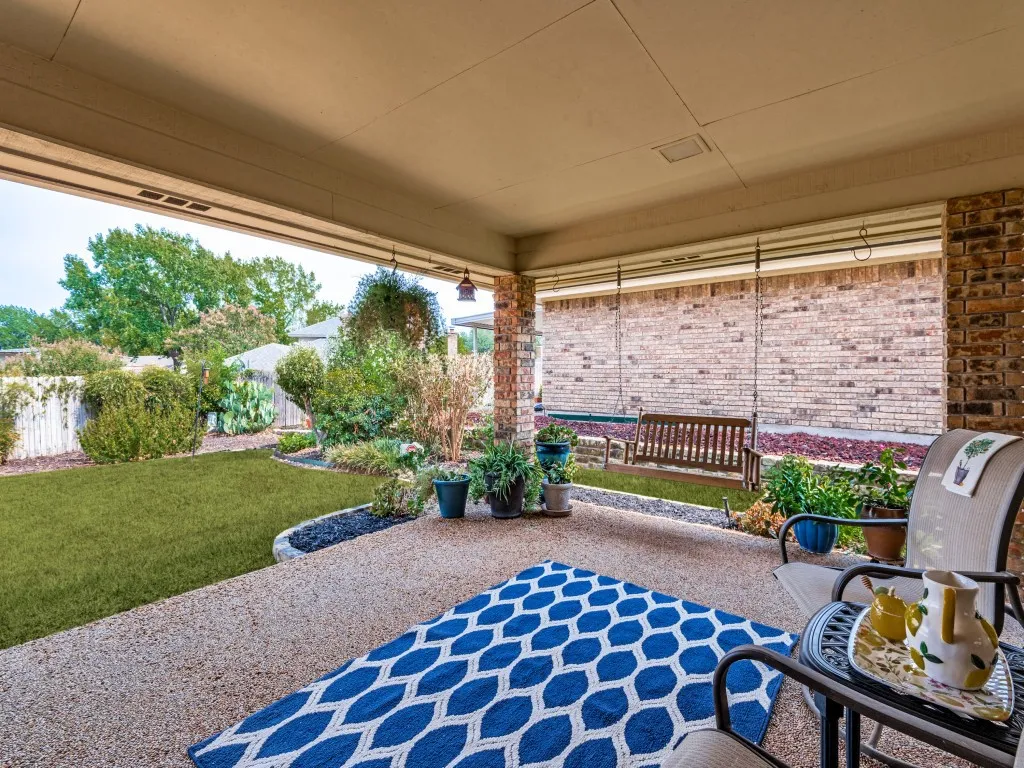 A favorite feature for most, this covered patio offers a break from our busy world. Note the hanging porch swing that stays with the house!