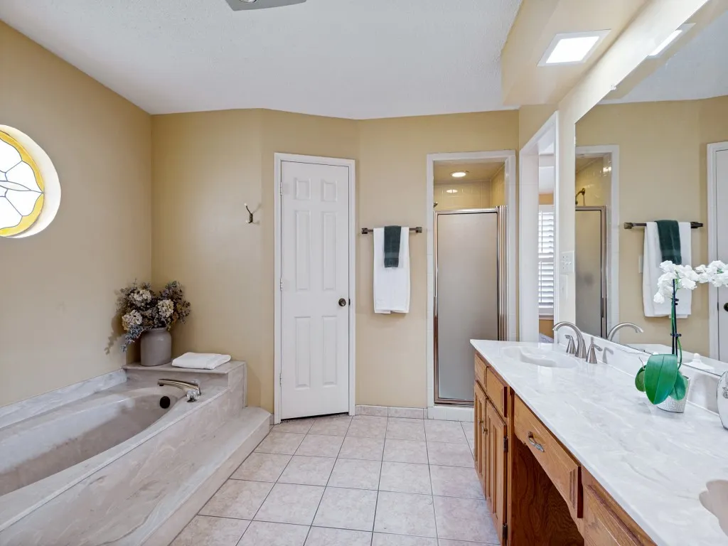 The primary bath includes 2 walk-in closets, separate shower, garden bathtub and dual vanity with knee space to sit down.