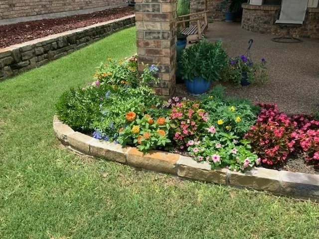 Landscape beds around the back patio in cooler days. It is the perfect place to garden your favorite Spring flowers.