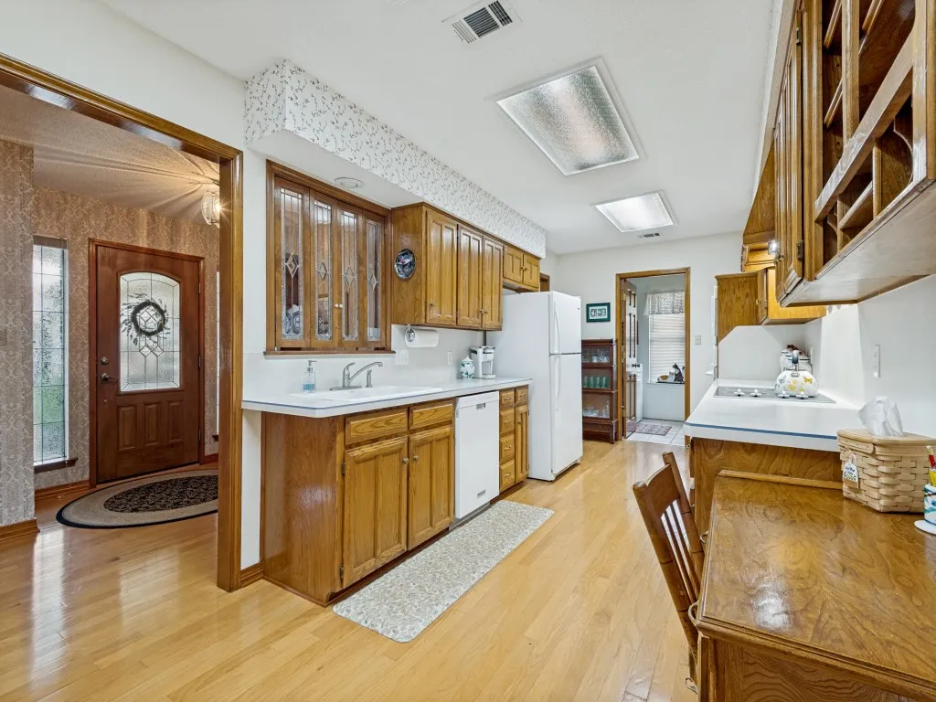 The room at the far end is the utility room and it has a closet that could be a 2nd pantry.