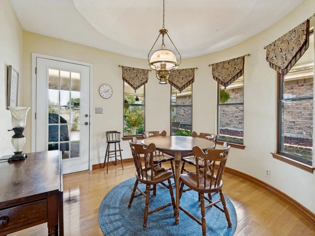 The breakfast room is spacious with a curved wall of windows. Coffee anyone?