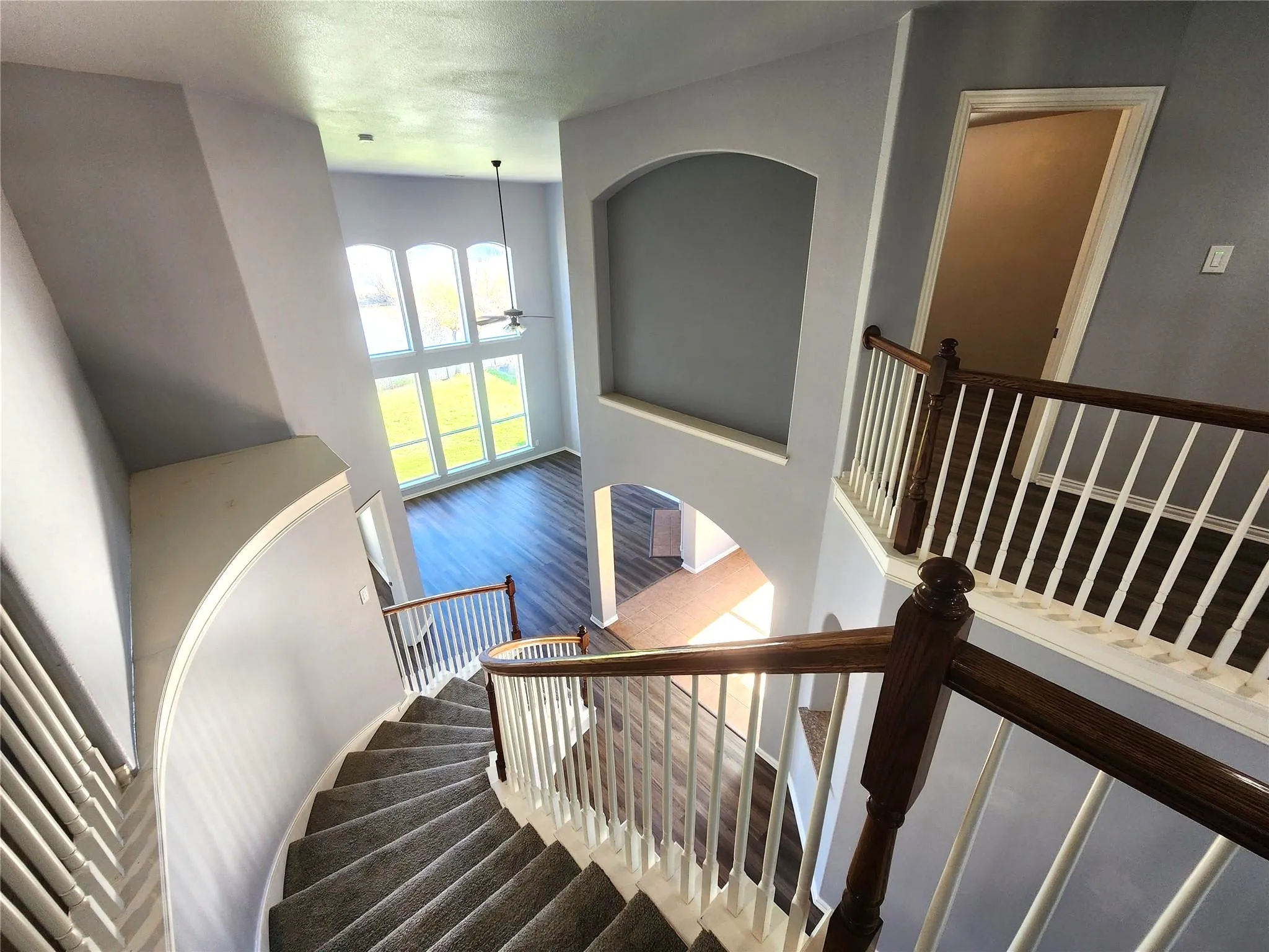 Grand curved staircase with carpeted treads