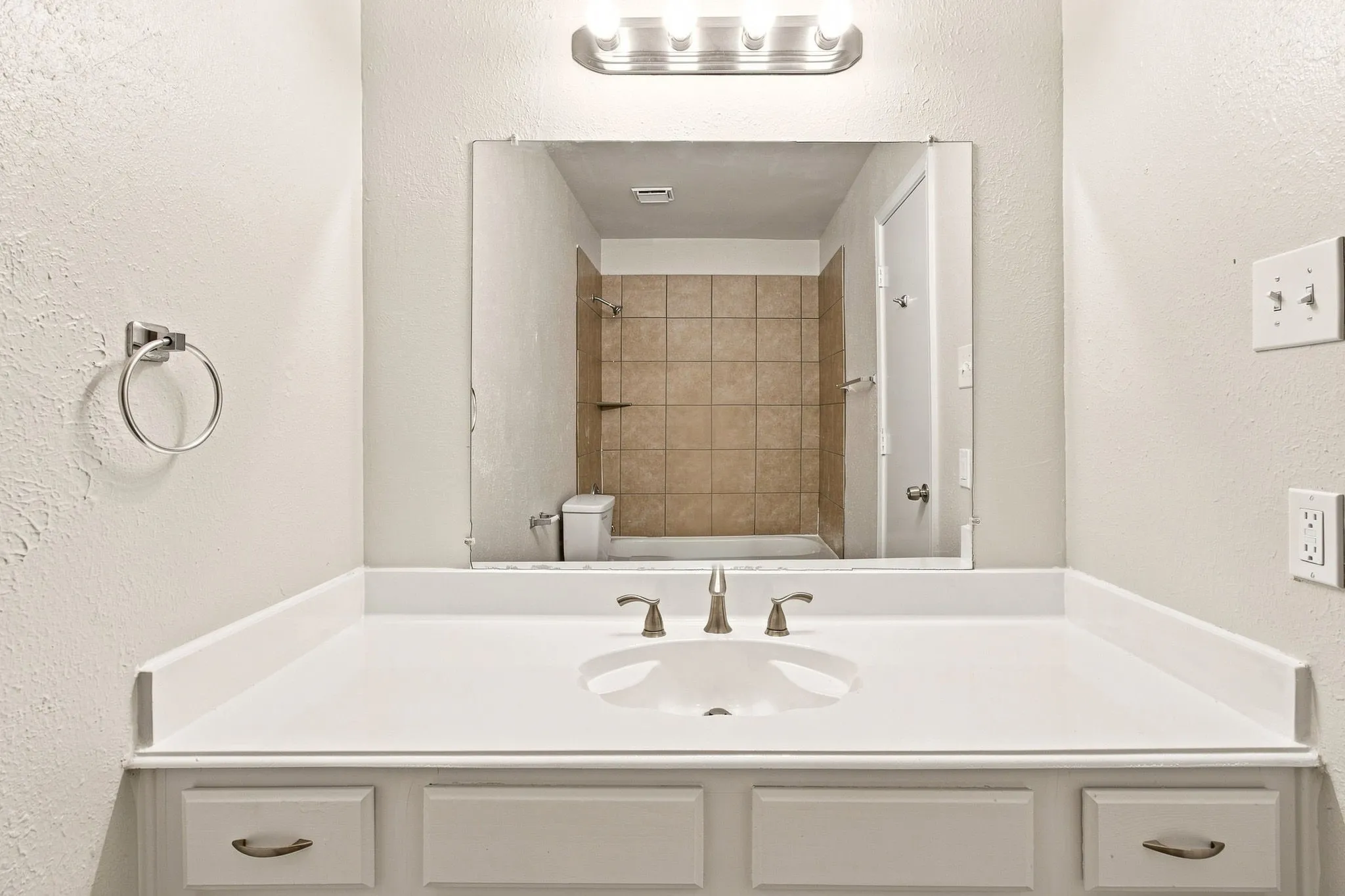 White vanity with an integrated sink and brushed nickel hardware