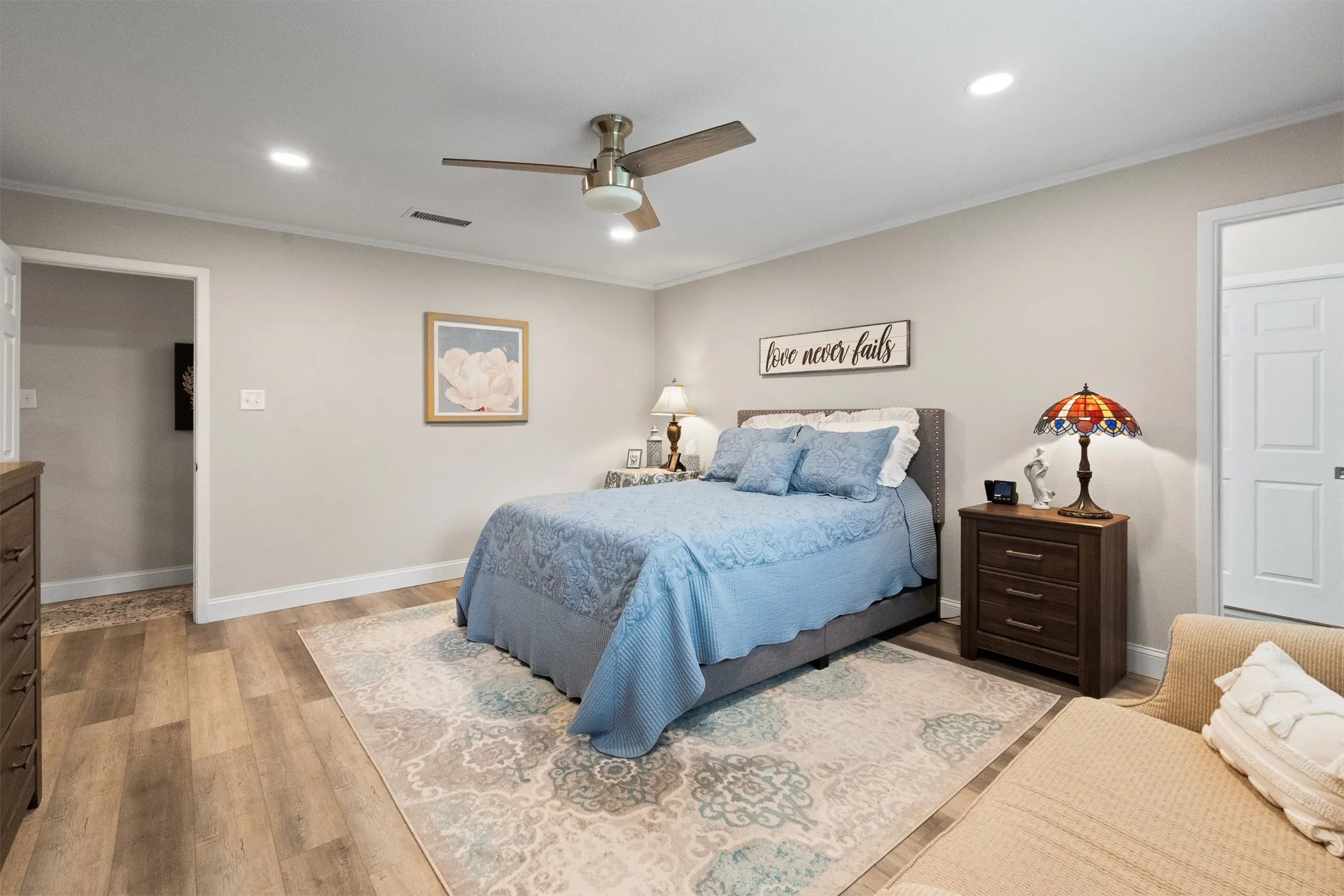 Recessed lighting, wood-finish flooring, ceiling fan, and white trim molding
