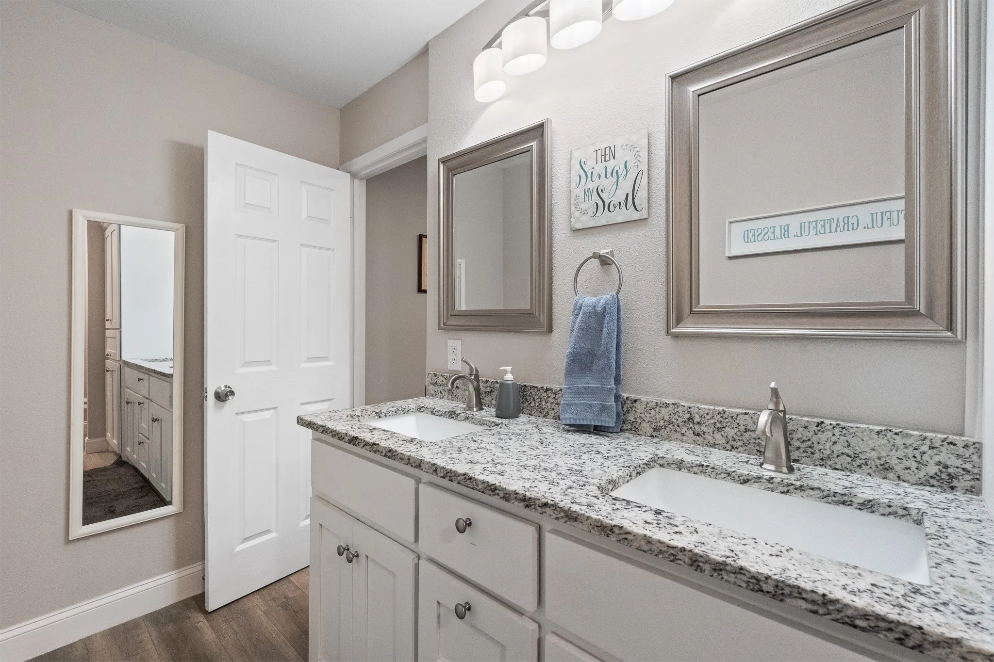 Dual vanity with undermount sinks, granite countertops, and brushed nickel fixtures