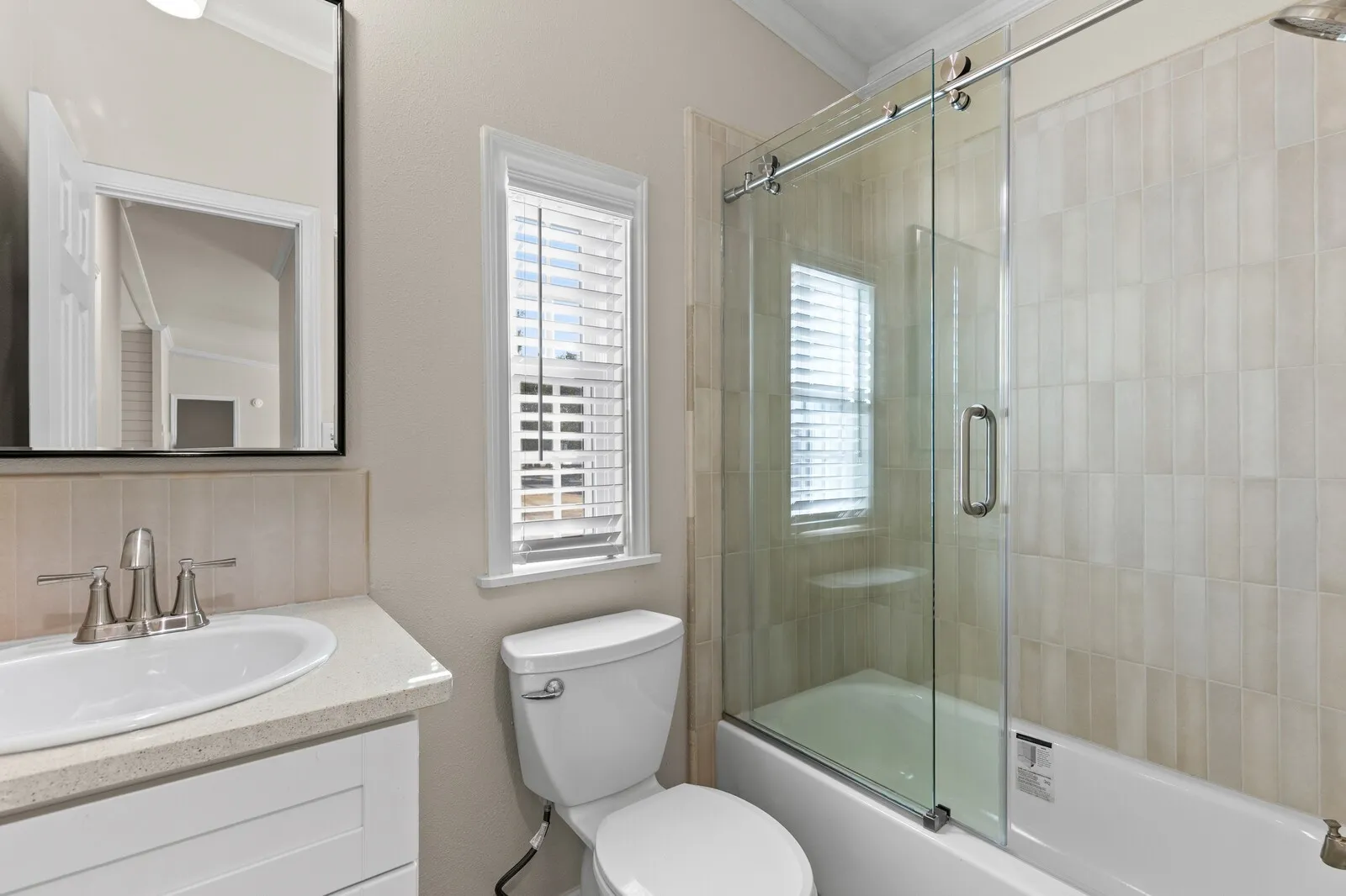 White vanity with a neutral countertop and integrated sink