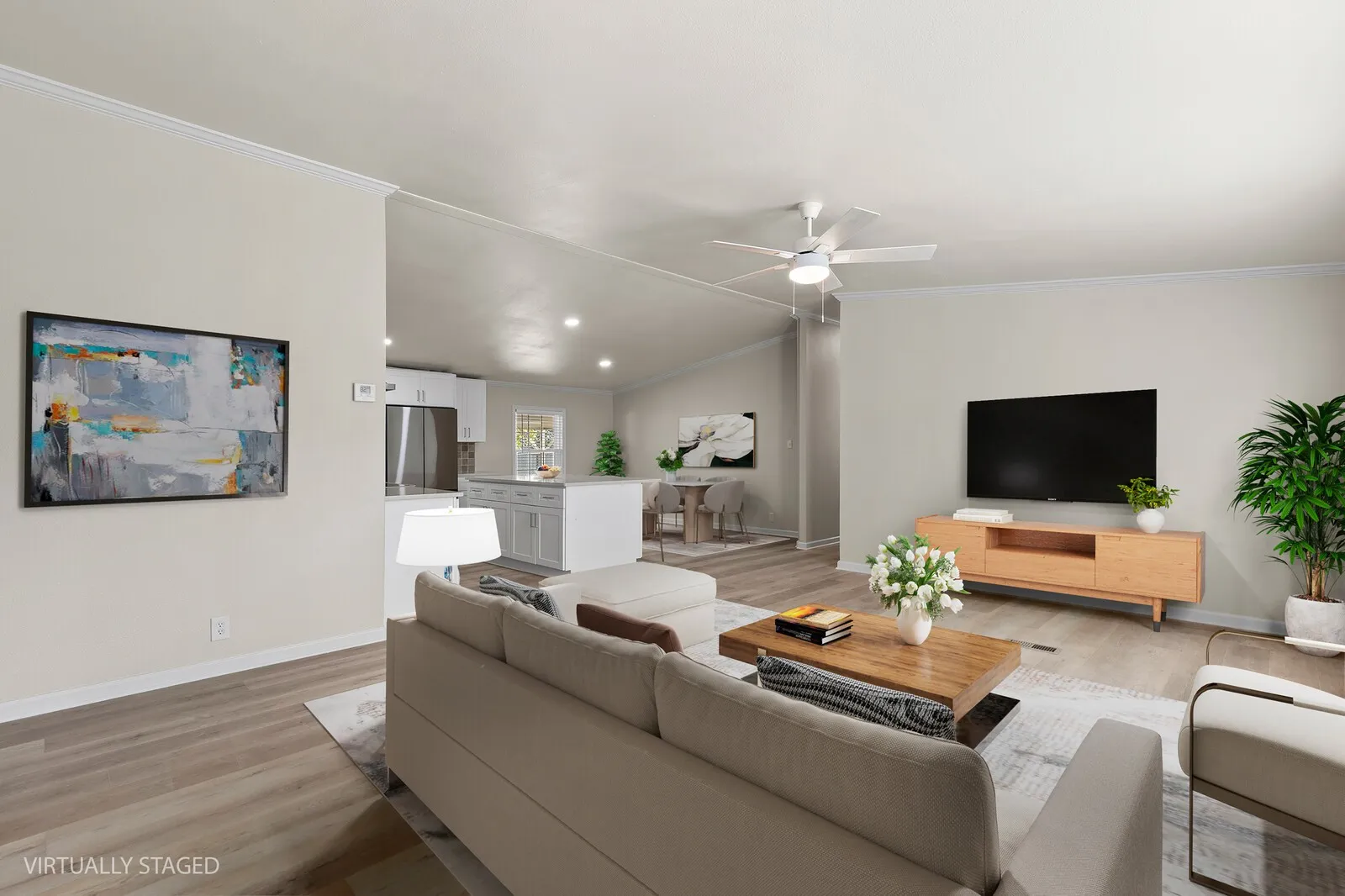 Open-concept living space featuring wood-finish flooring, recessed lighting, and a ceiling fan