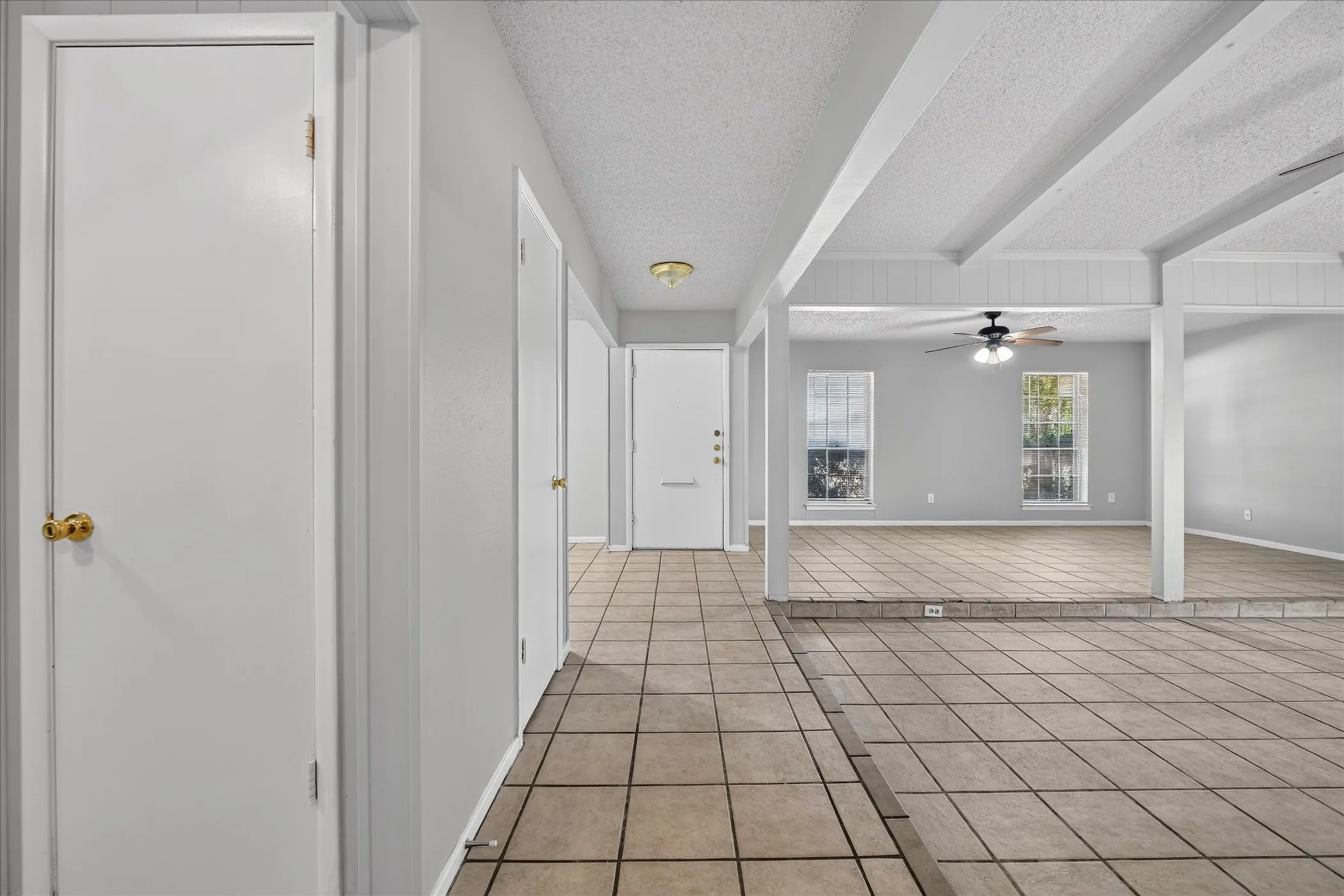 Tiled flooring throughout the main level, featuring a recessed living area
