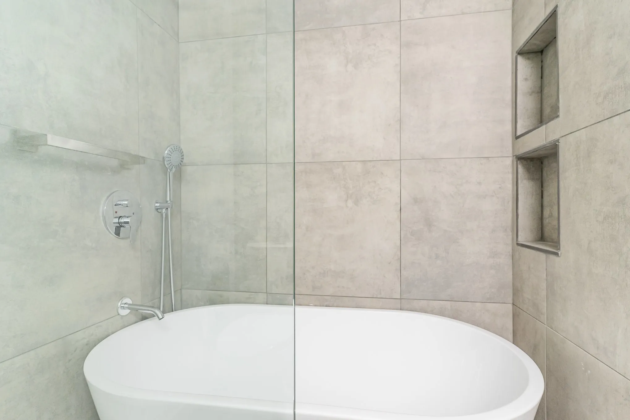 Bathroom with a bathing tub and tile walls