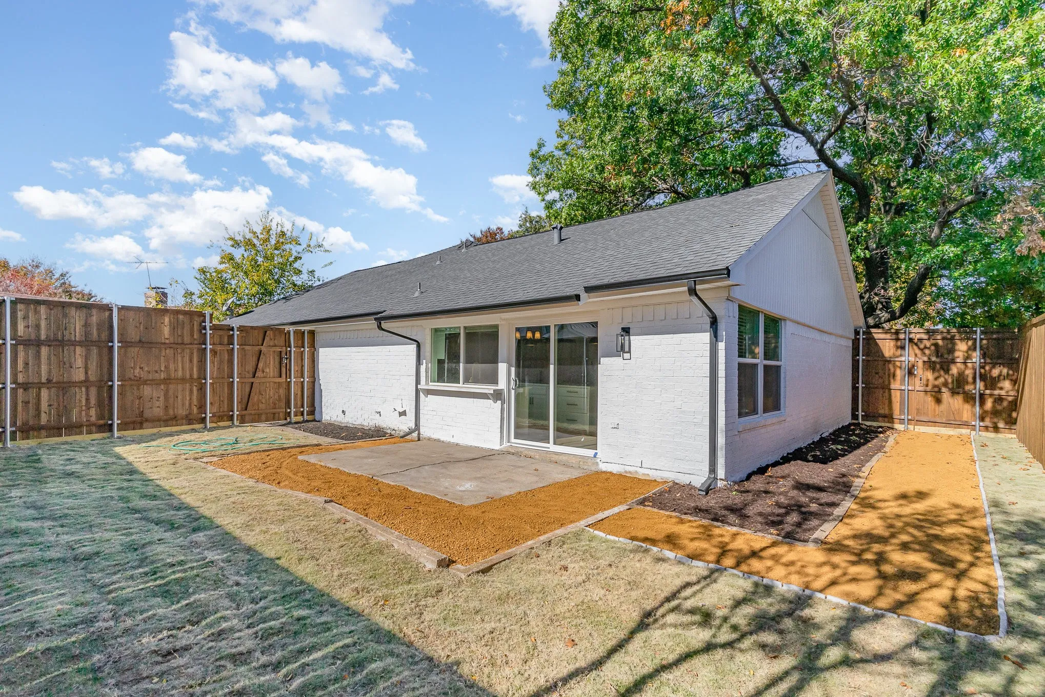 Back of property featuring a lawn and a patio