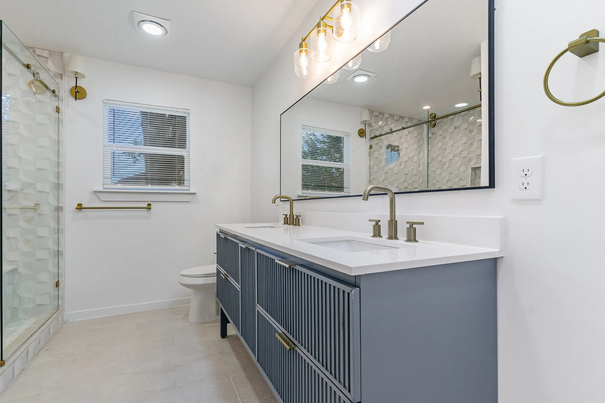 Bathroom featuring vanity, an enclosed shower, and toilet