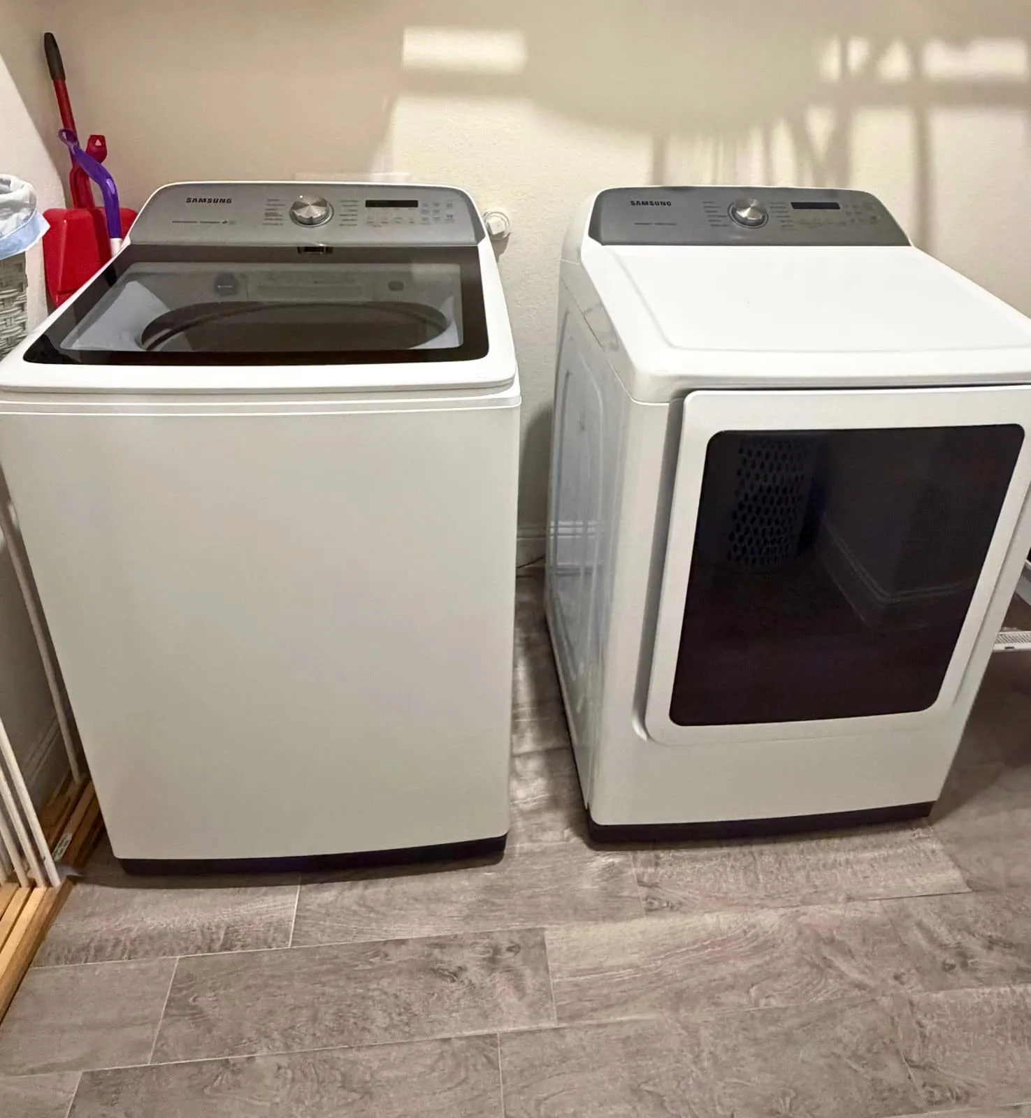 Dedicated laundry area featuring a top-load washer and front-load dryer