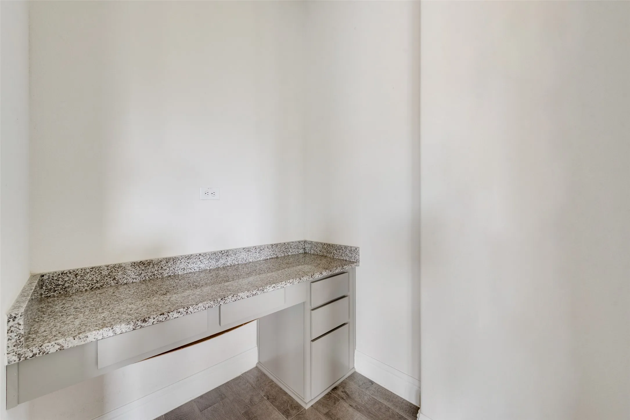 Unfurnished office with dark hardwood / wood-style flooring