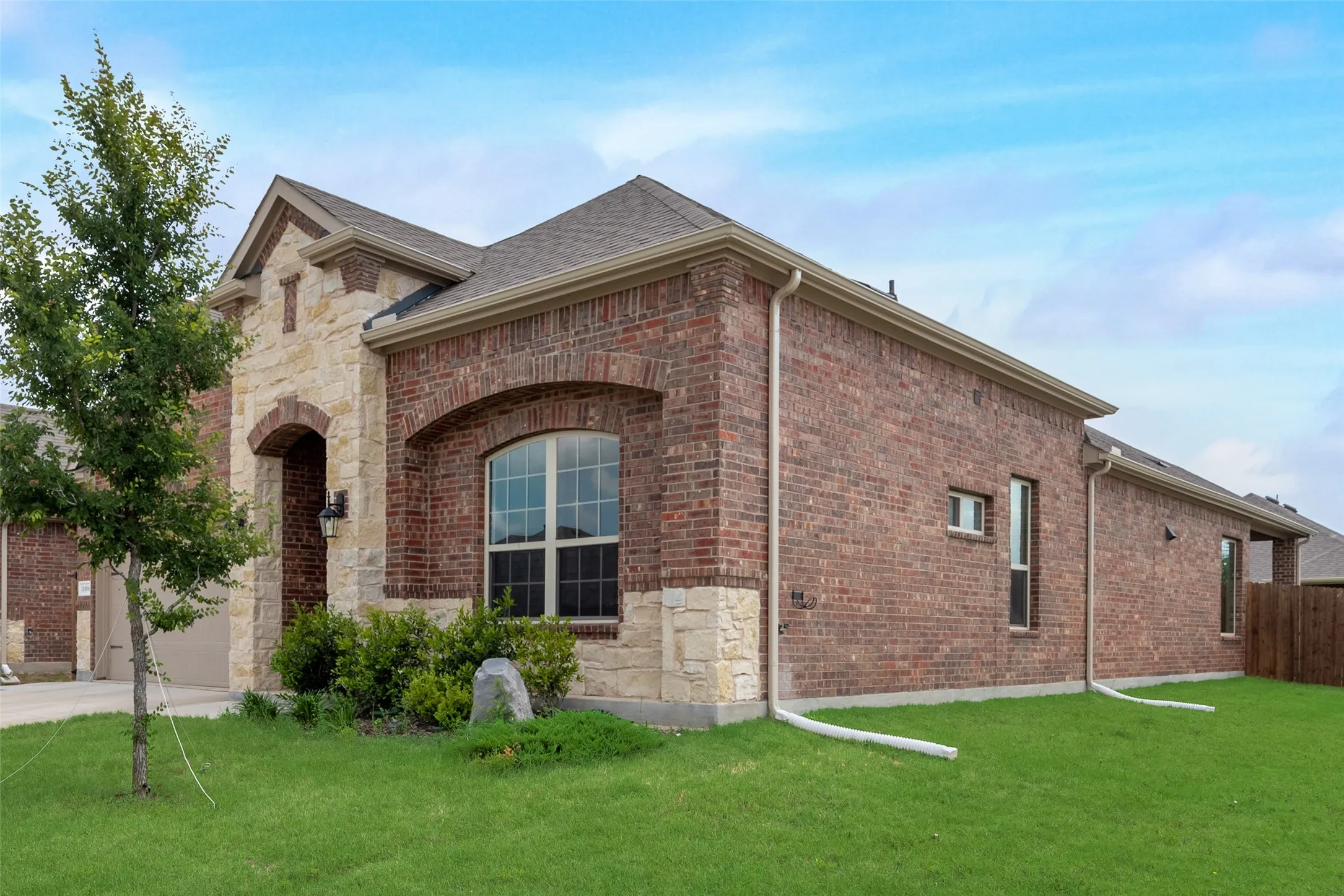 View of home's exterior featuring a garage and a yard