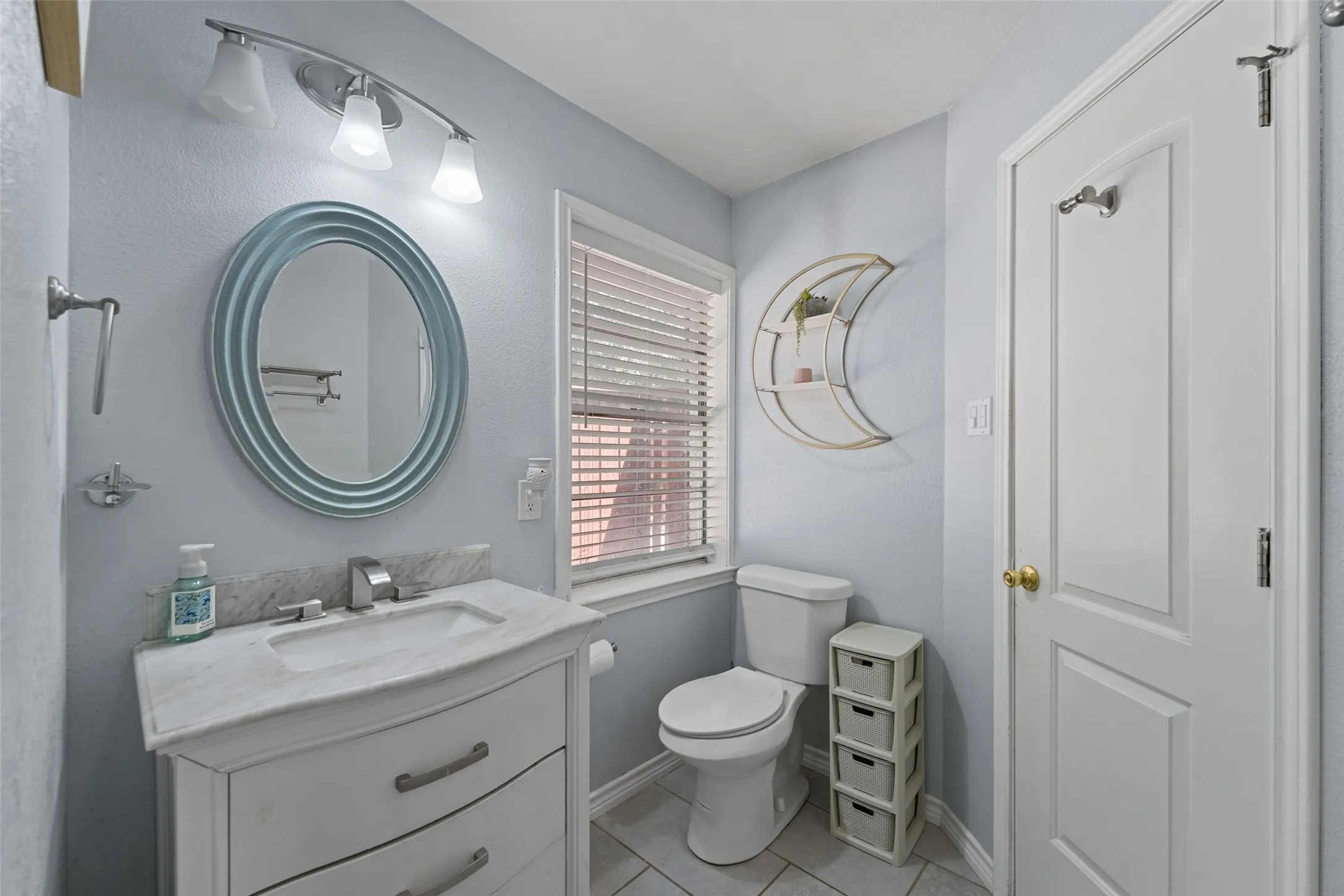 Vanity with integrated sink, stone countertop, and chrome faucet