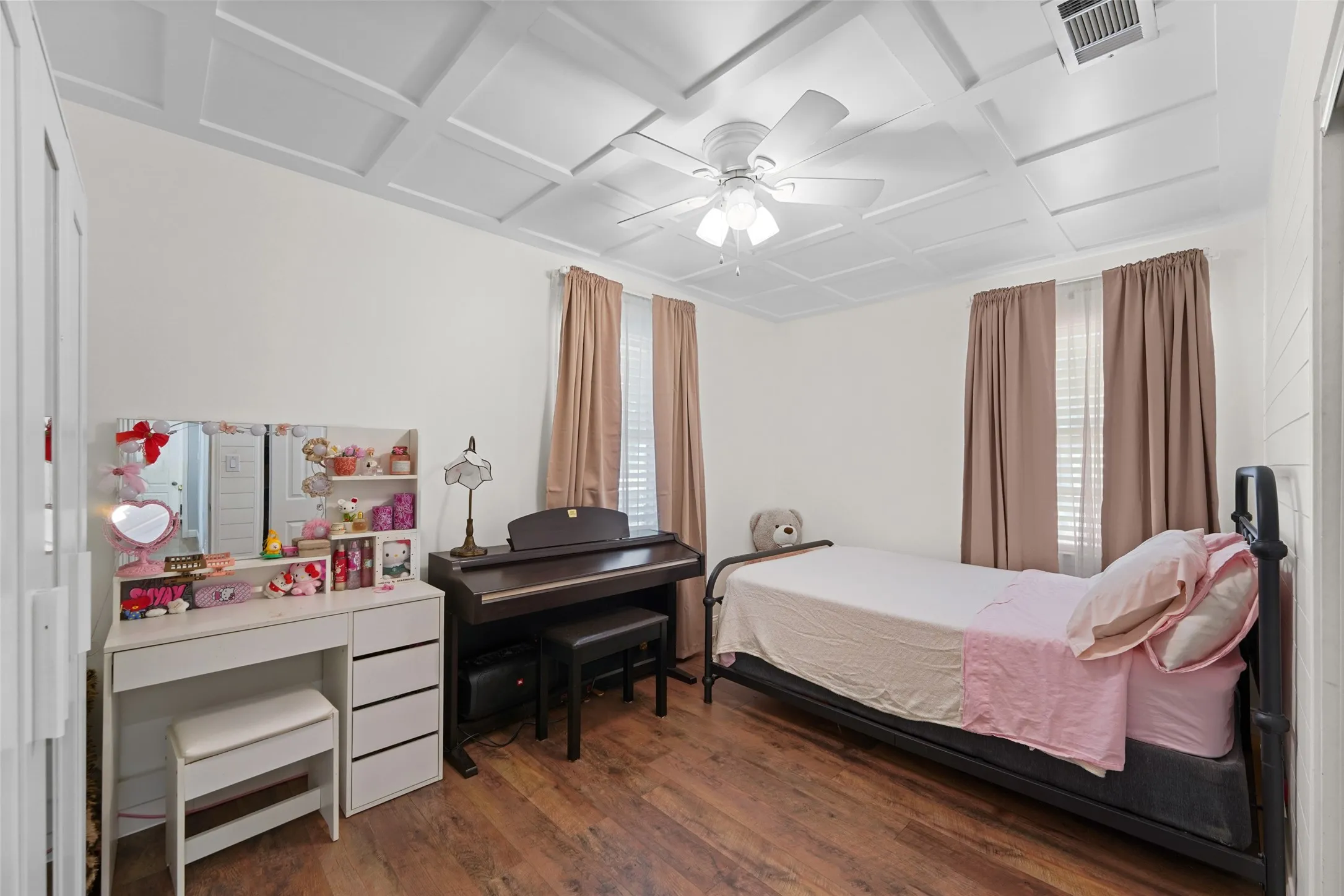 Wood-finish flooring with white walls and a coffered ceiling