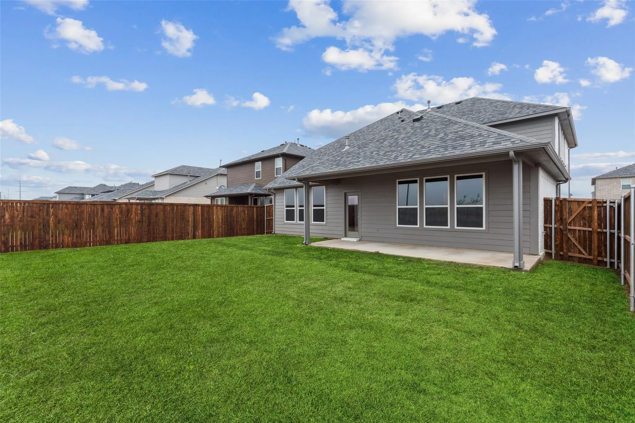 Back of property with a yard and a patio area