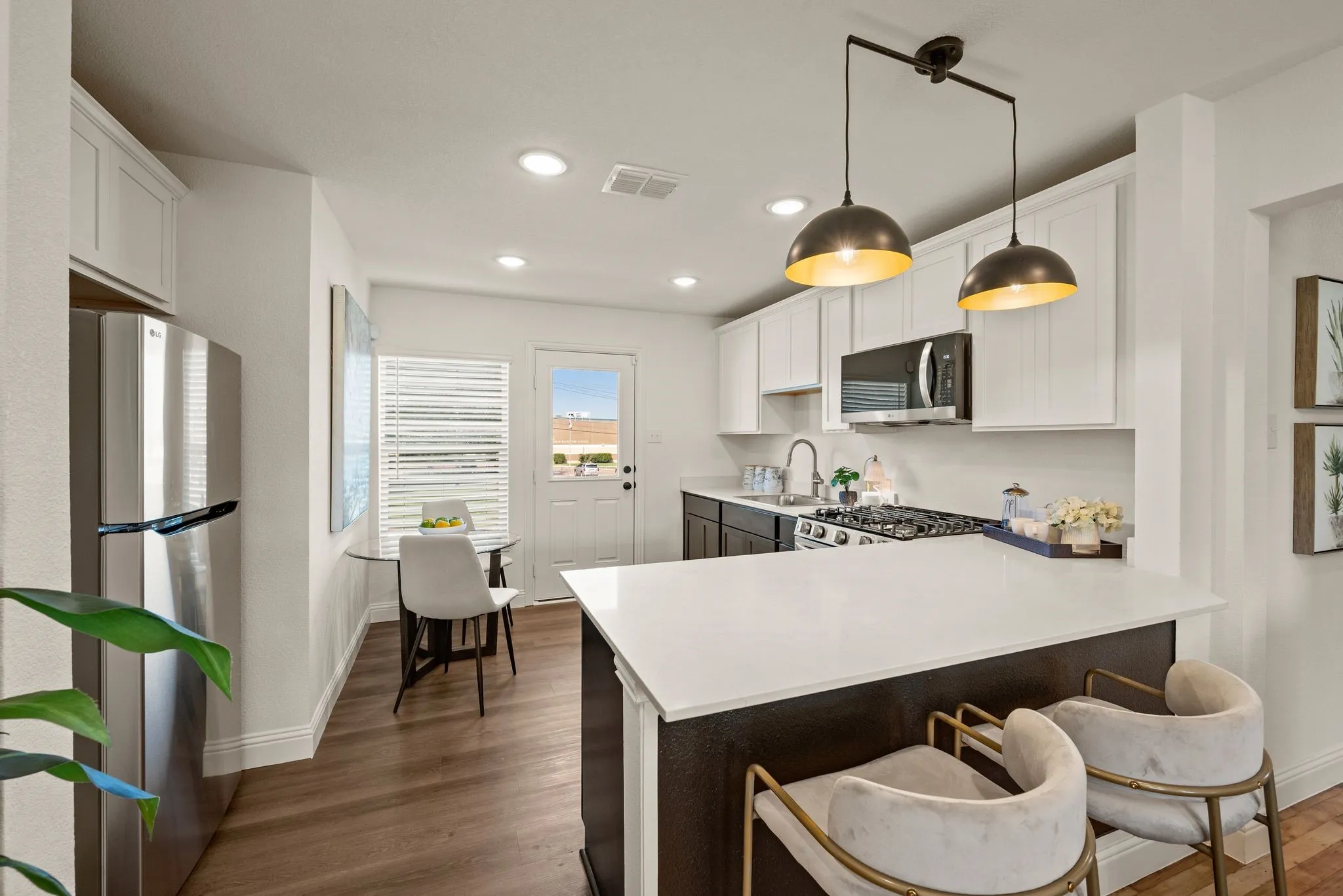 Kitchen has Luxury Vinyl Plank; Quartz countertops; Counter-height dining; Water line to Fridge (not shown)