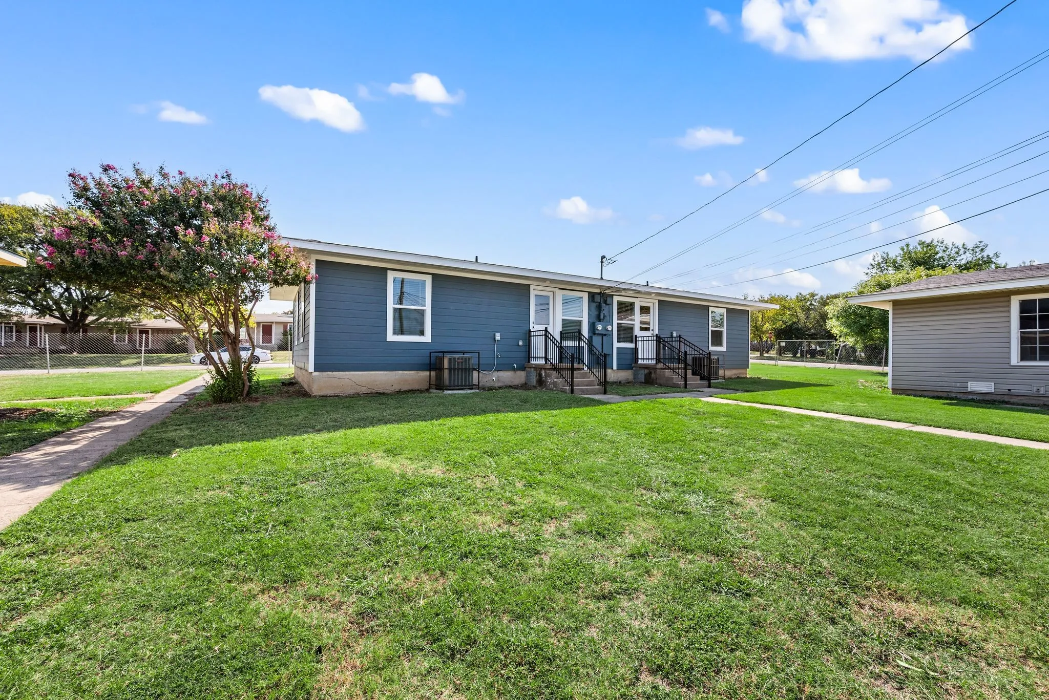 Sidewalks; Back Stoop; Grass aplenty in common areas