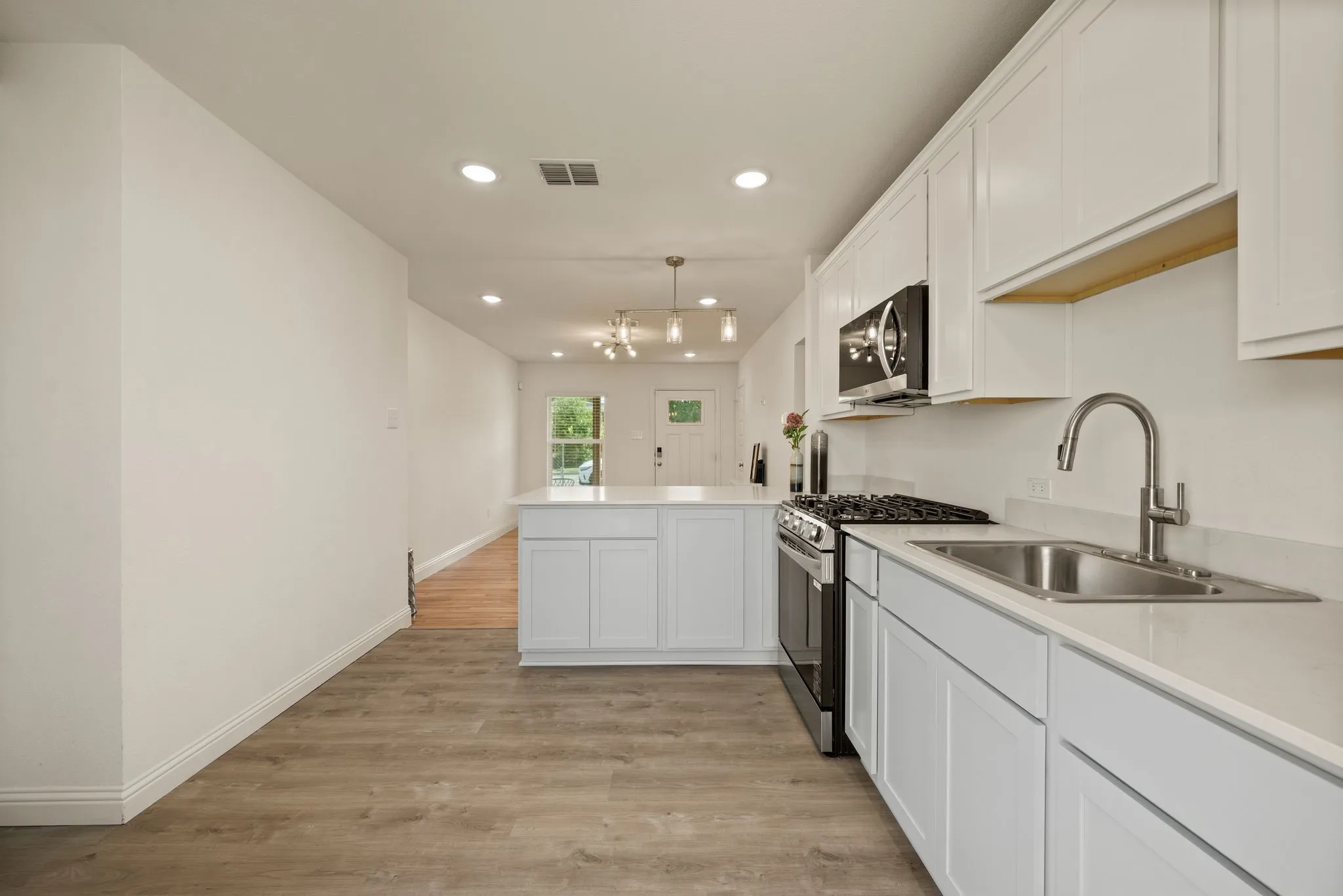 Spray nozzle at sink; Plentiful Cabinetry