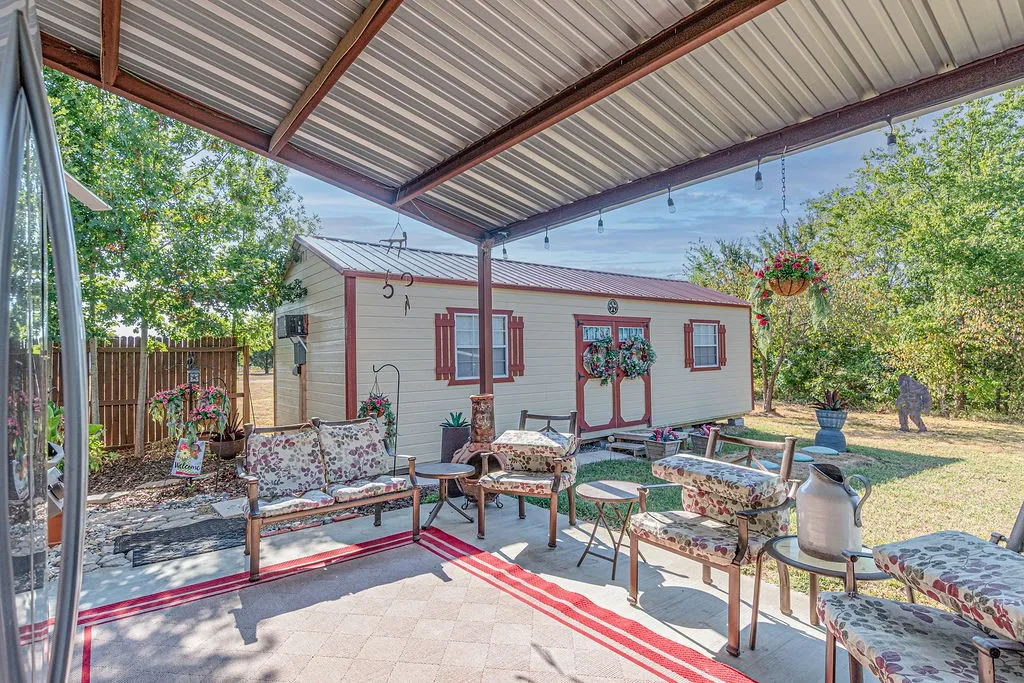 Side porch and one of three workshops with electric, heat, and air.