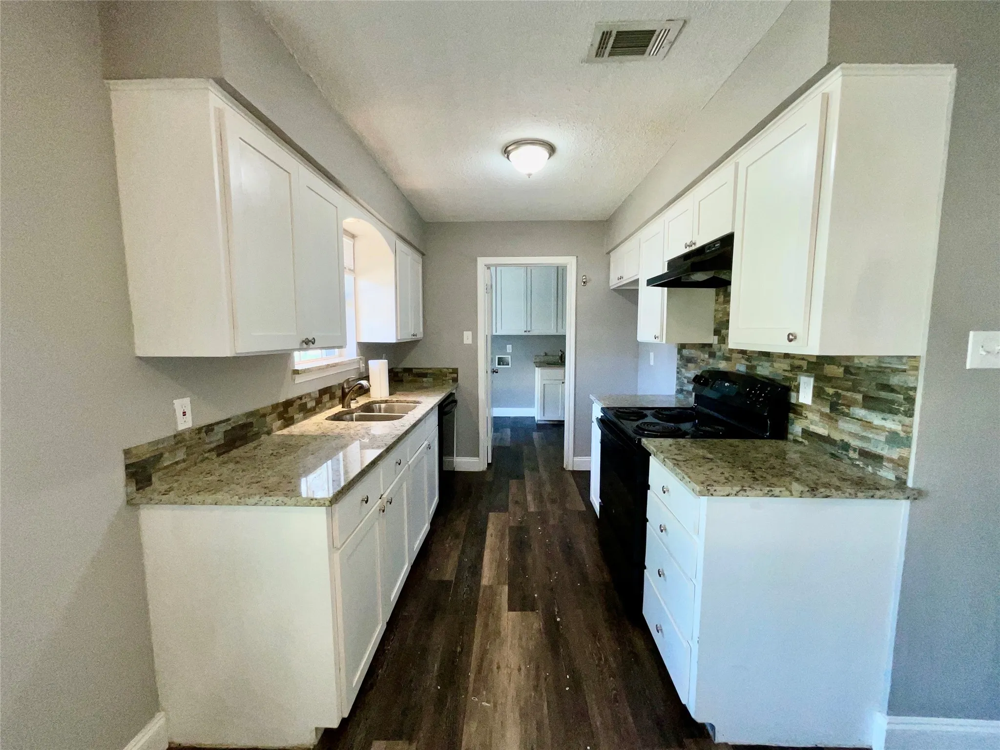     Updated Kitchen with Granite Countertops, Tile Backsplash & Abundant Cabinet Storage