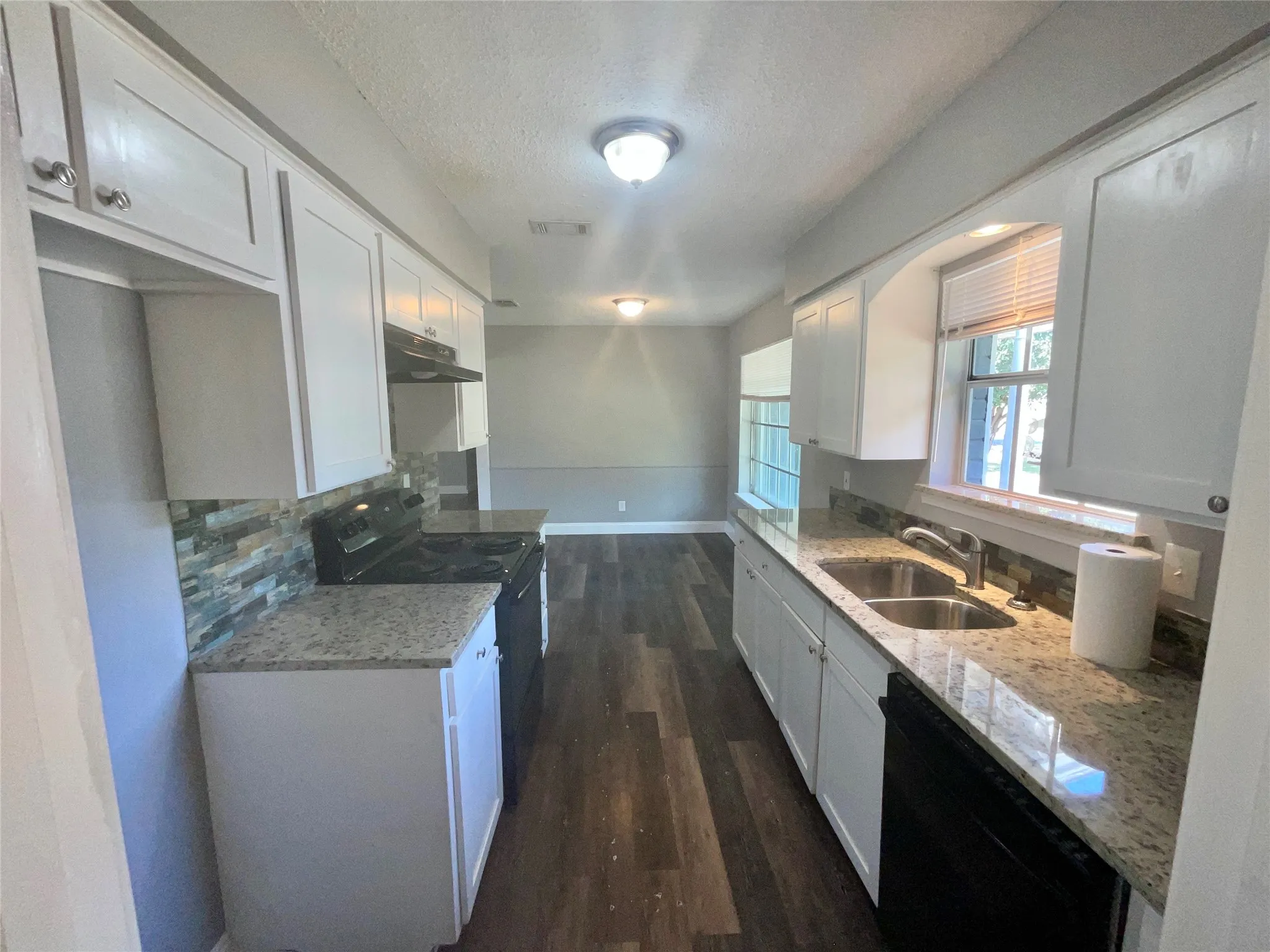     Updated Kitchen Featuring Granite Countertops & Luxury Vinyl Plank Flooring