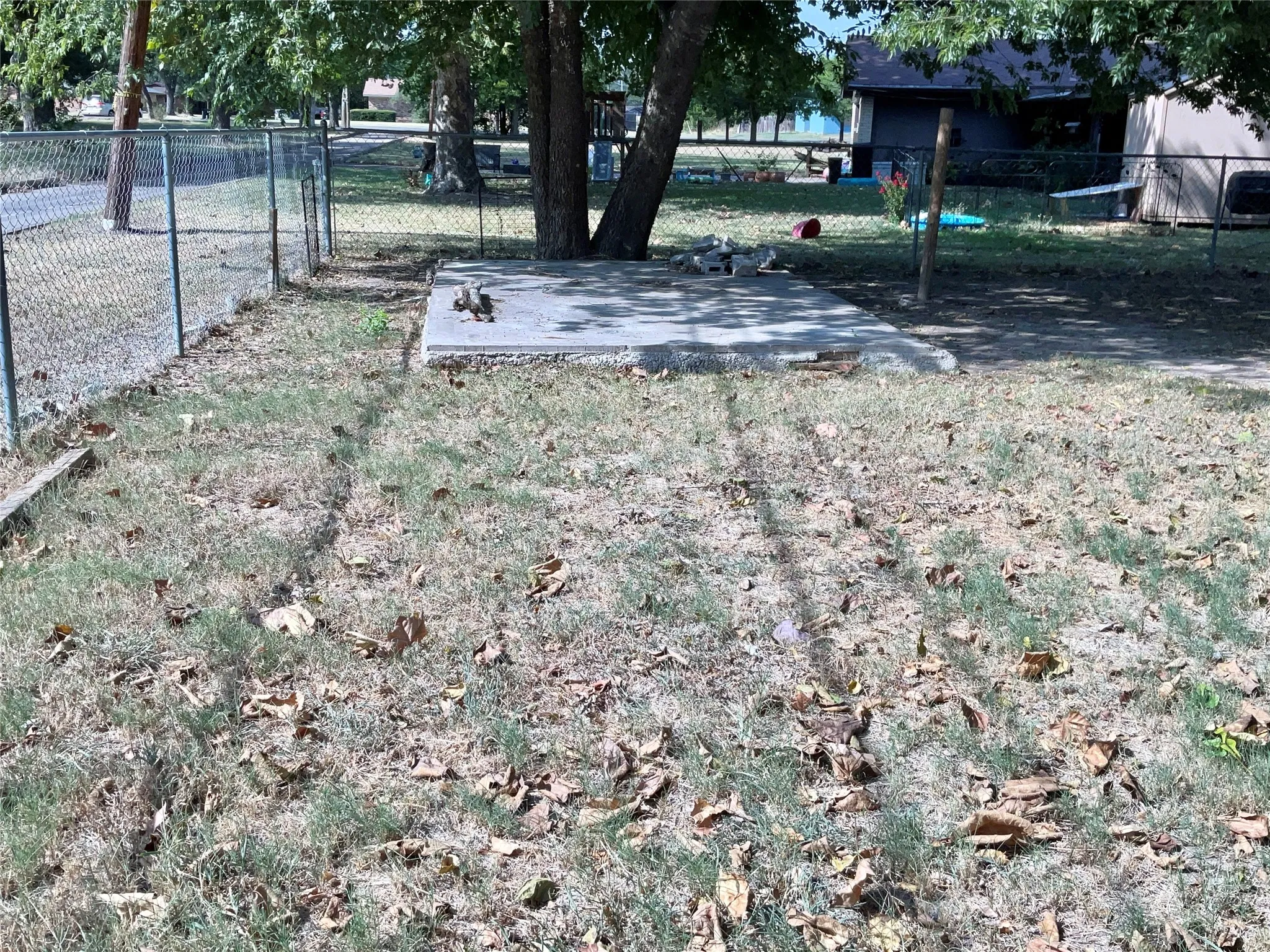 Versatile Backyard Concrete Slab Offering Potential for a Storage Building, Additional Patio, or Outdoor Living Space